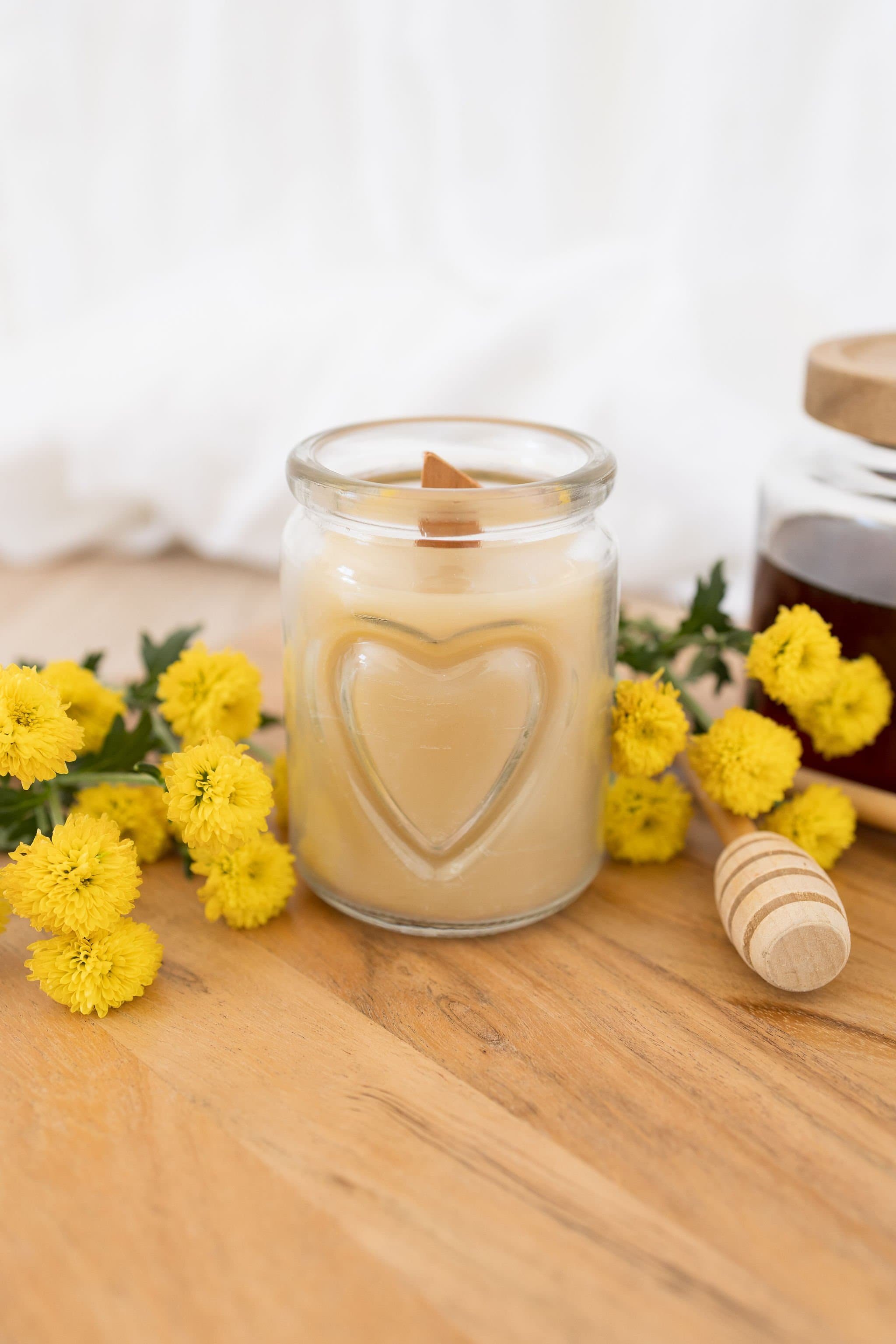 Handmade beeswax candle in a heart design glass with wooden wick, natural eco-luxury gift