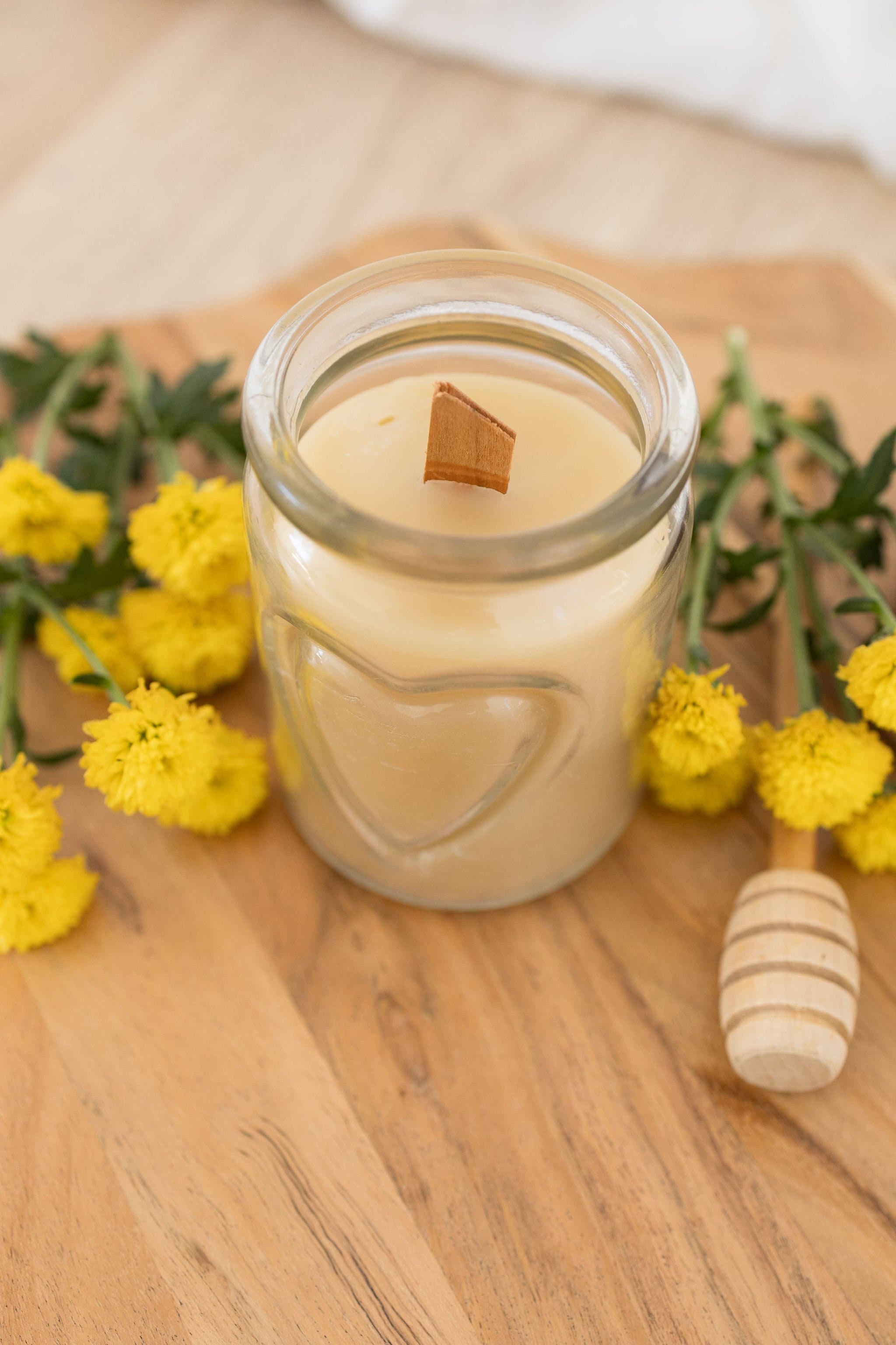Handmade beeswax candle in a heart design glass with wooden wick, natural eco-luxury gift