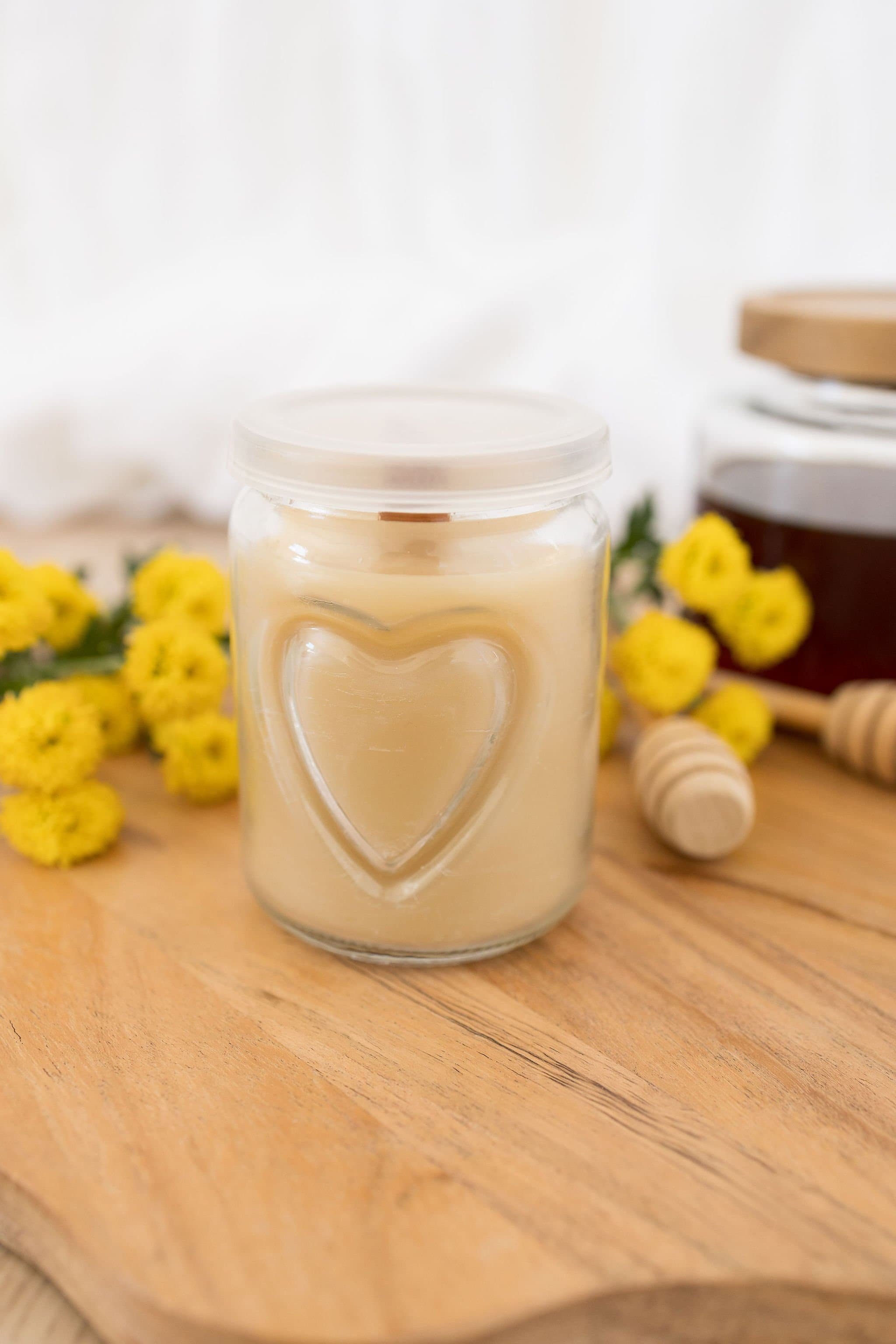 Handmade beeswax candle in a heart design glass with wooden wick, natural eco-luxury gift
