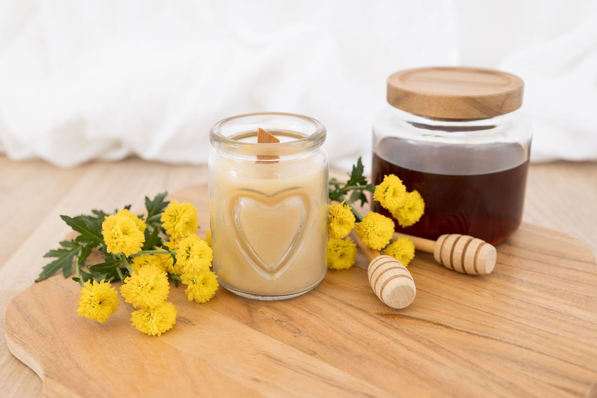 Handmade beeswax candle in a heart design glass with wooden wick, natural eco-luxury gift