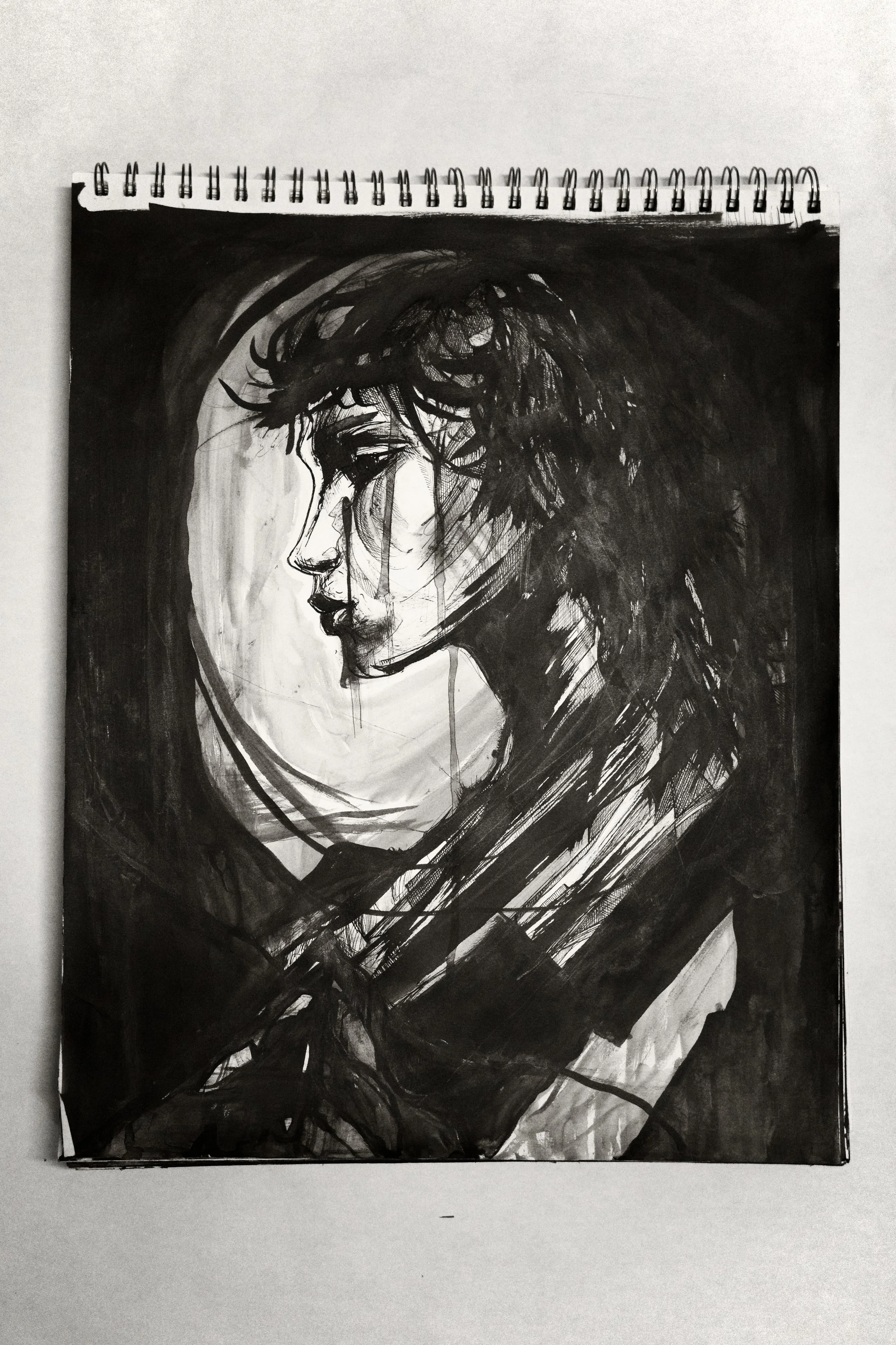 Black and white portrait sketch of a woman with short, messy hair, viewed in profile, with a serious expression.