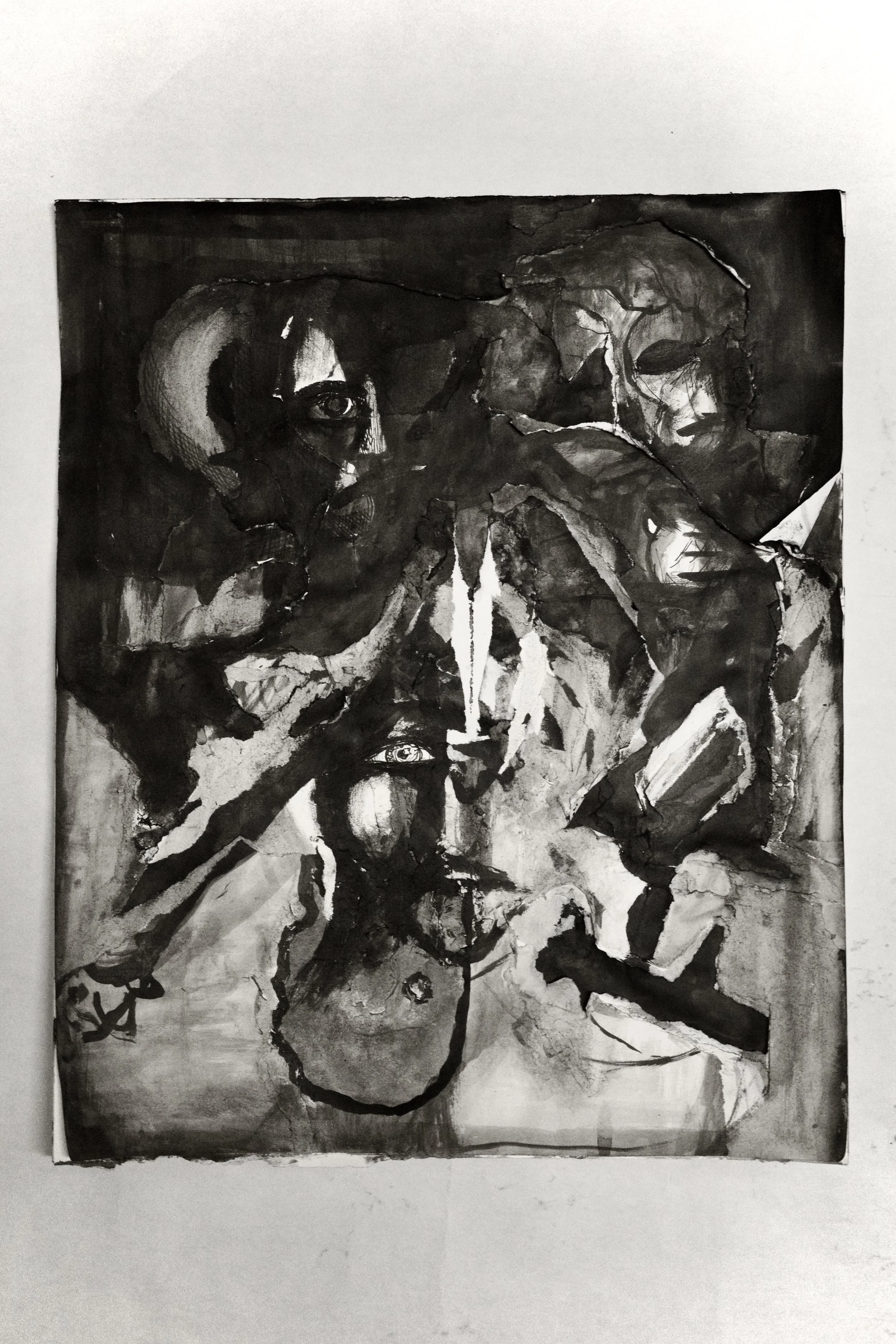 Black and white abstract painting featuring distorted human faces, eyes, a candle, and various geometric shapes.