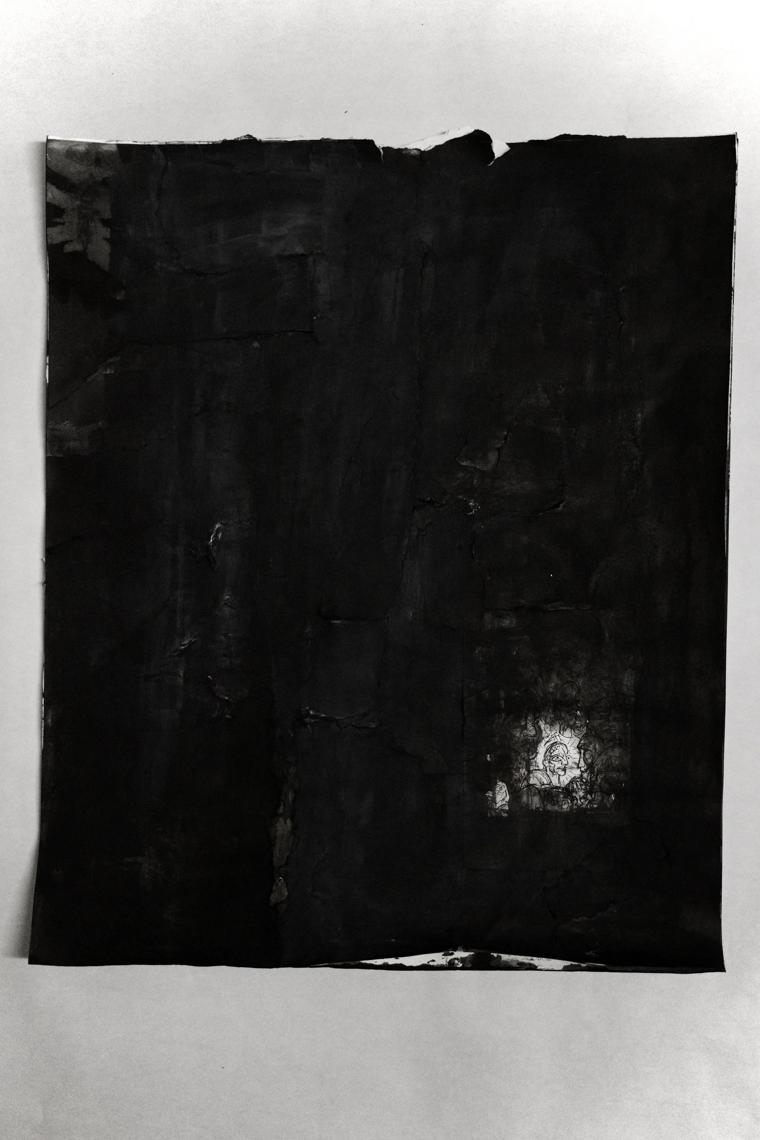 A black textured paper with a small, detailed line drawing of a person's face in the lower right corner.