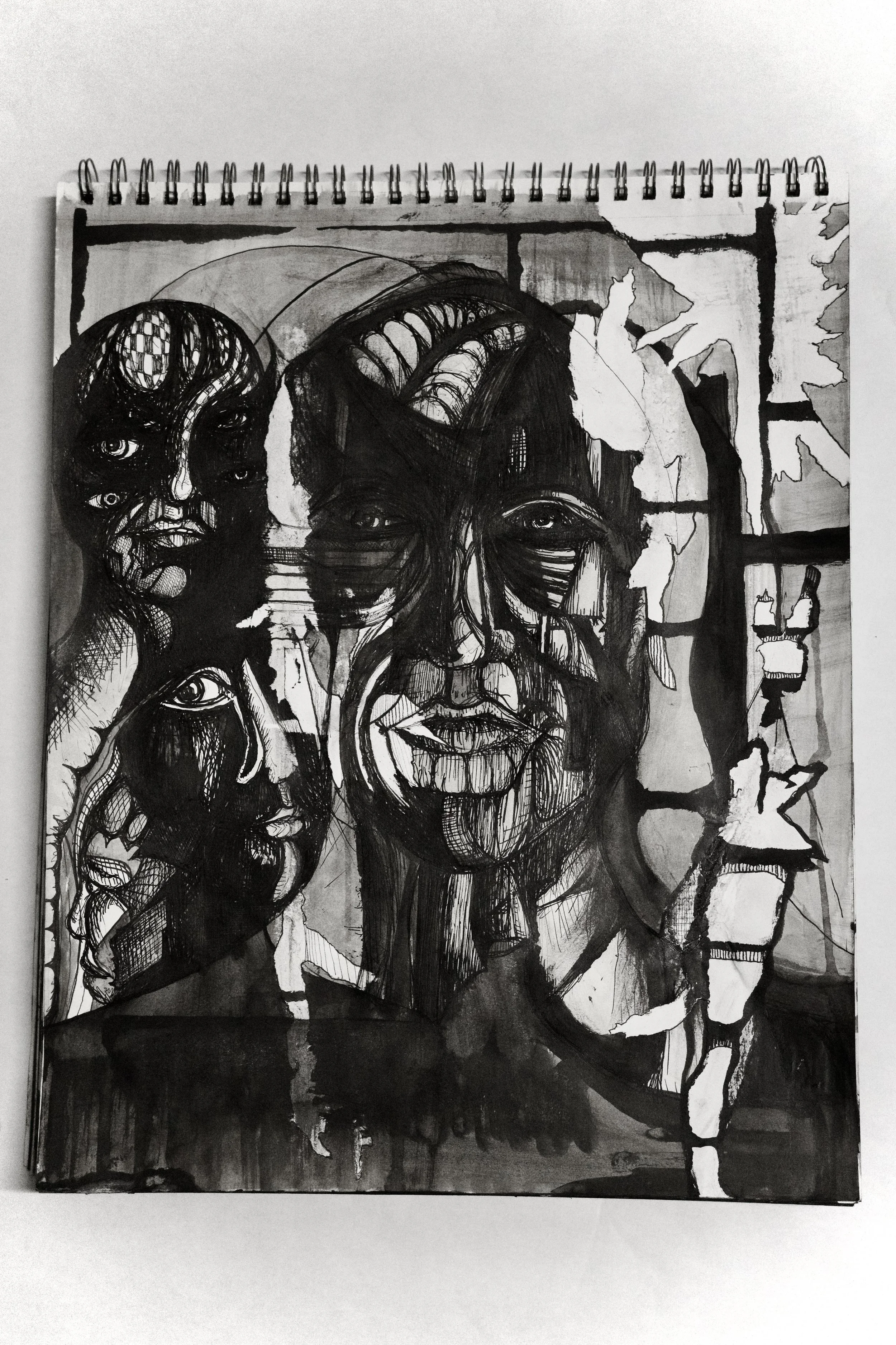 Black and white abstract drawing of multiple faces with various expressions and eyes, set against a layered background with window and leaves.