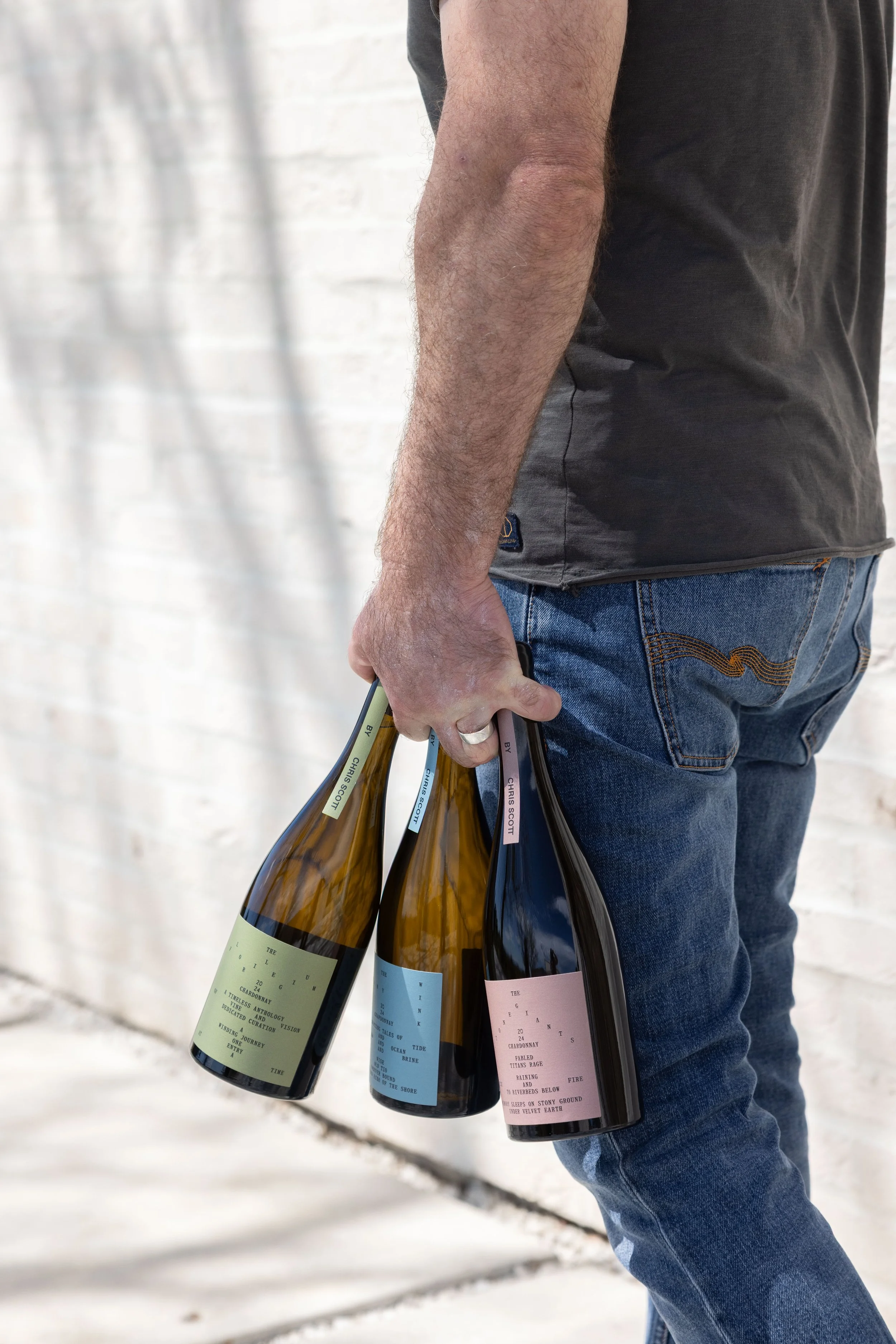 Chris Holding Three Wines.JPG