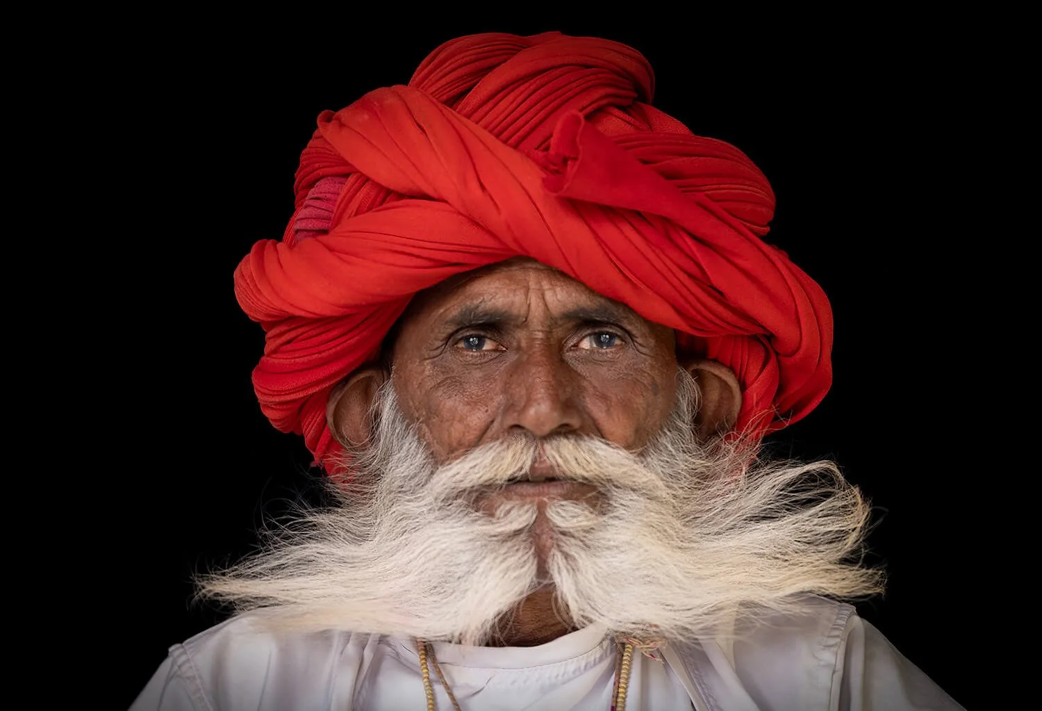 A member of the Rabari tribe with his majestic mustache. The mustache is a sign of maturity and respect in the community. Rabiri are typically herders.  Photographed in Jawai, India.