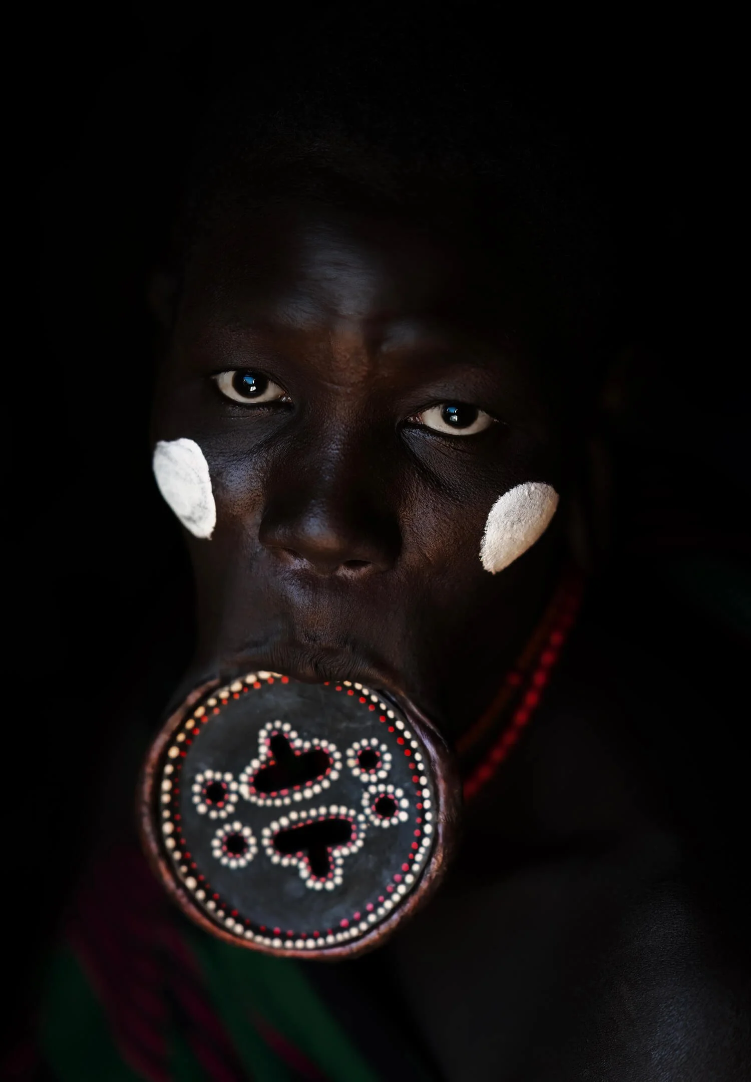 The Mursi tribe women are known for their unique lip plates and body art.  The lip disc is a symbol of strength, identity and beauty within their community.  Photographed in the Omo Valley, Ethiopia.