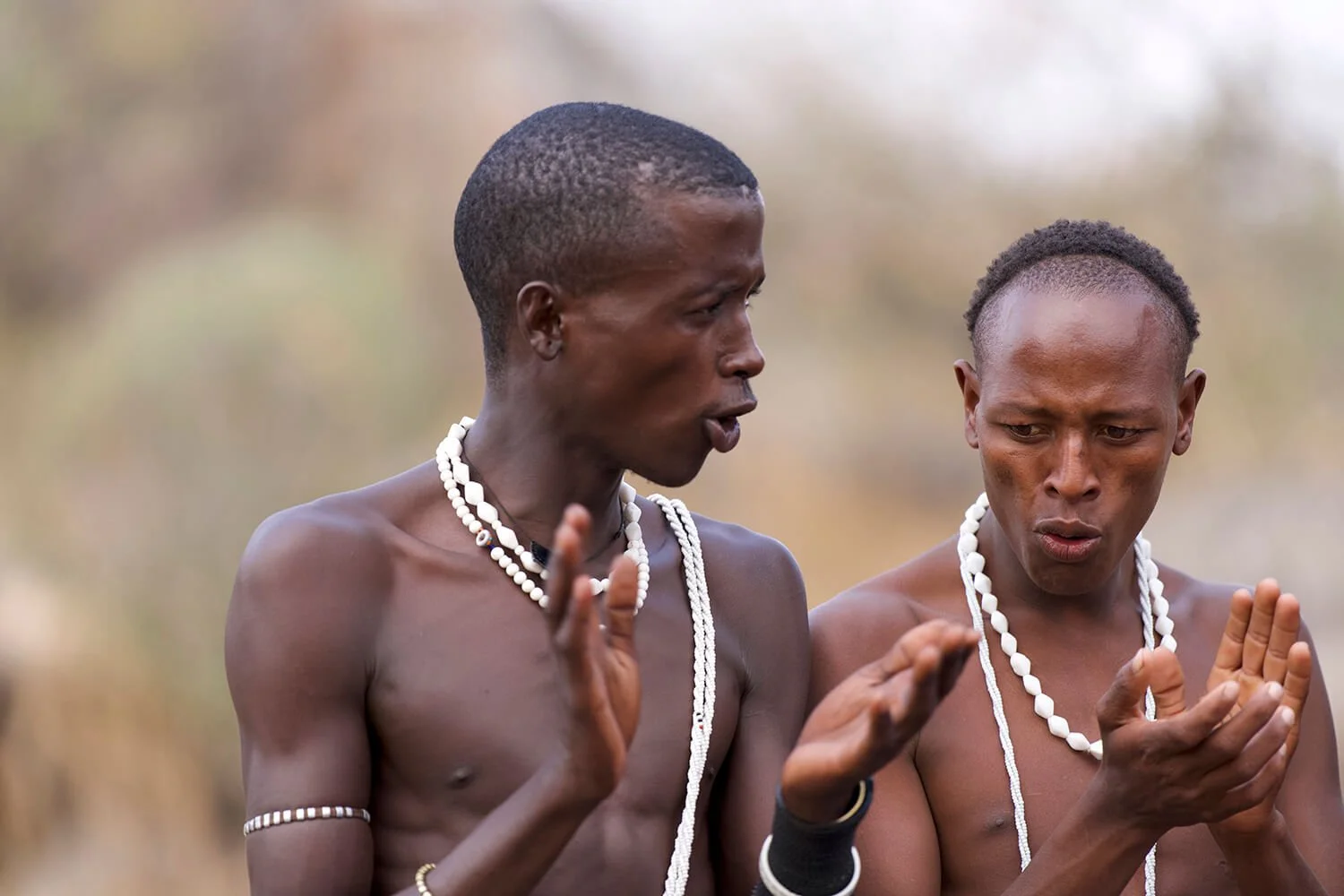 Two men from the Datooga tribe. They are participating in an evening dance ritual to meet  a bride.  Photographed in north-central Tanzania.