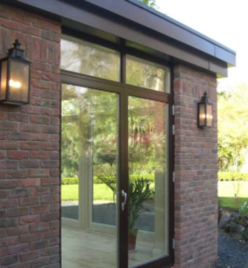 Exterior of a house with glass doors and brick walls