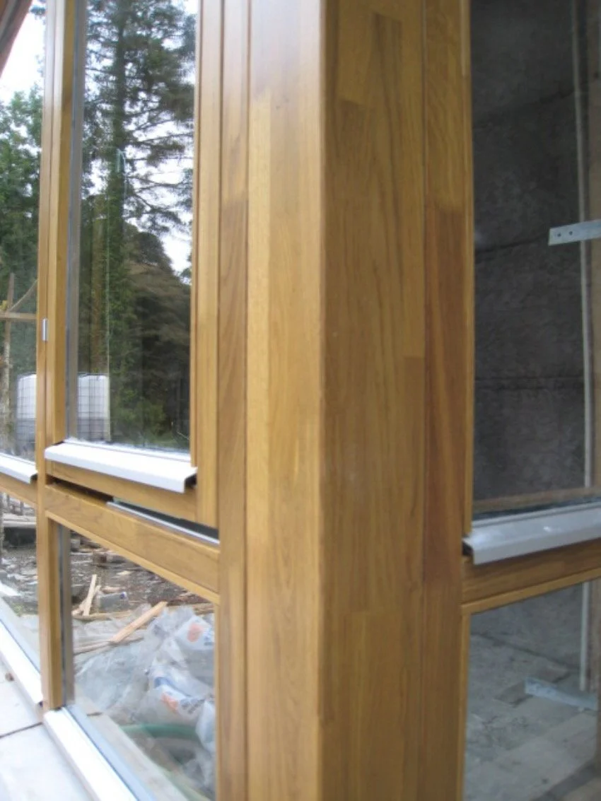 Close-up of wooden-framed glass windows and doors
