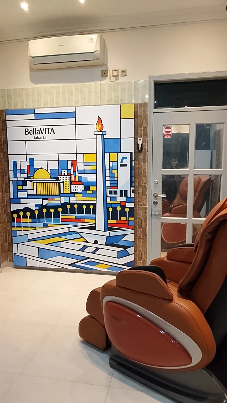 Room with a massage chair, treadmill, and sofa. Bella VITA Jakarta Sport's area