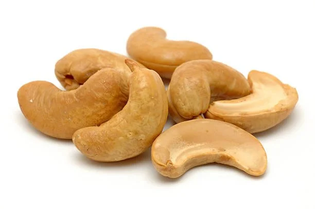 Close-up of roasted cashew nuts on a white background.