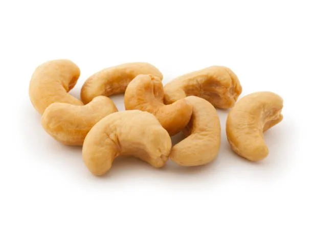 Close-up of roasted cashew nuts on a white background.