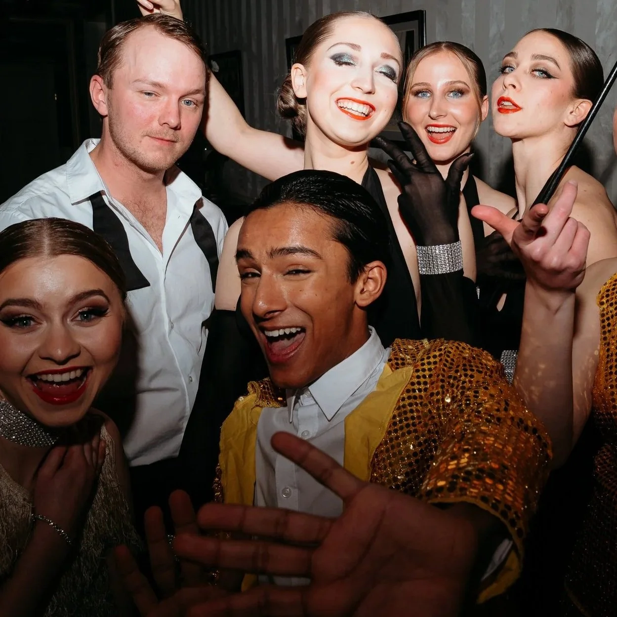 Stage performance with dancers in costumes on a lit platform