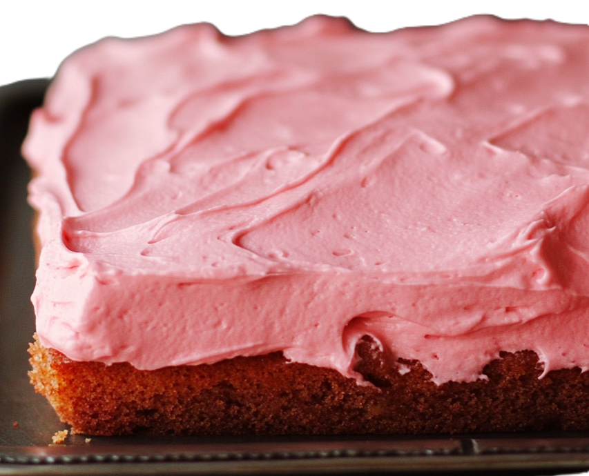 Close-up of a slice of strawberry cake — visible strawberry bits and airy interior.
