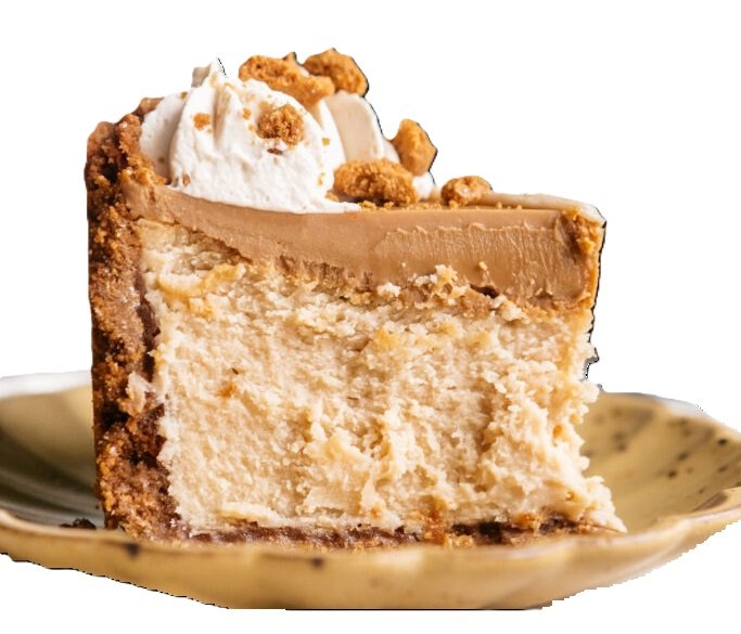 a slice of creamy cookie butter cheesecake on a plate