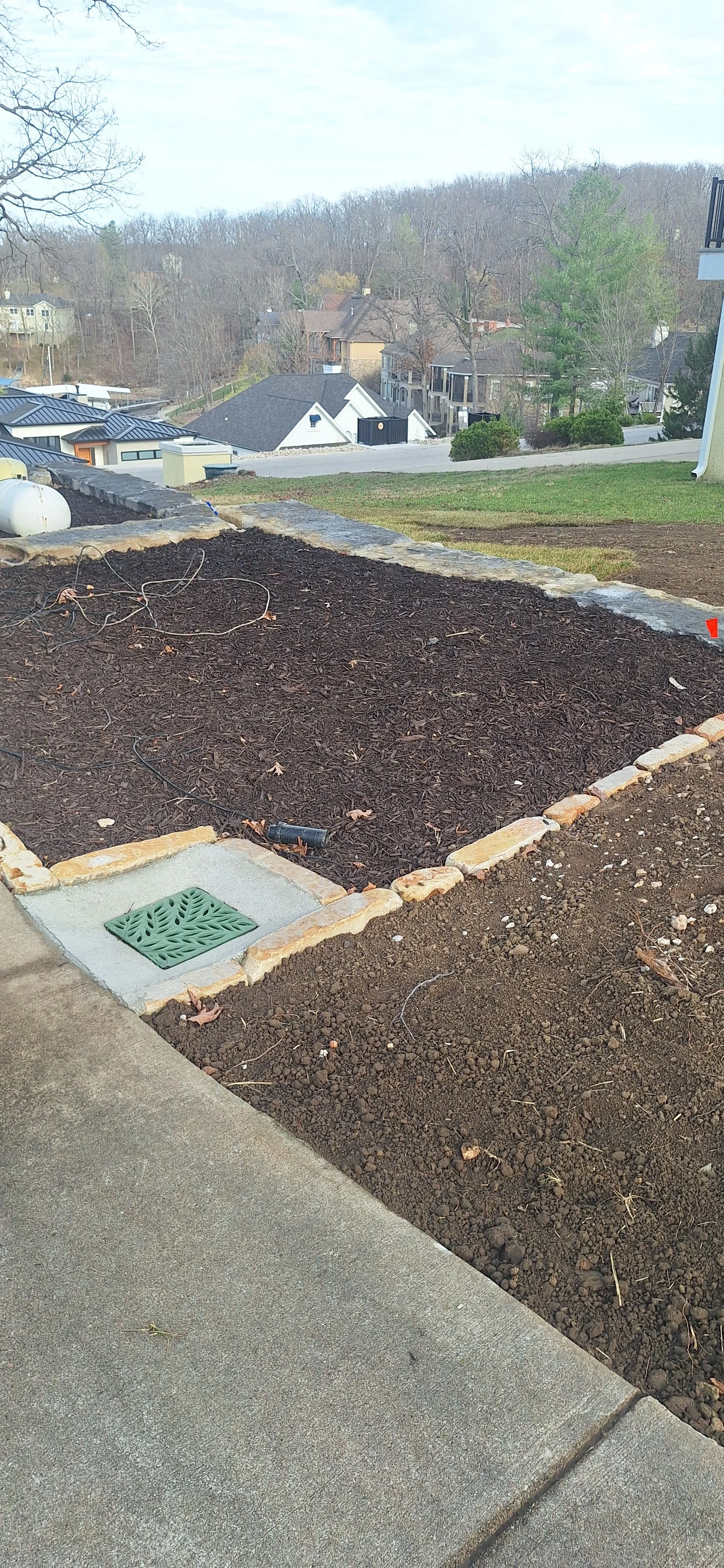 Stone edging, planting bed, mulch, Irrigation, corrected grade, prepping for sod.