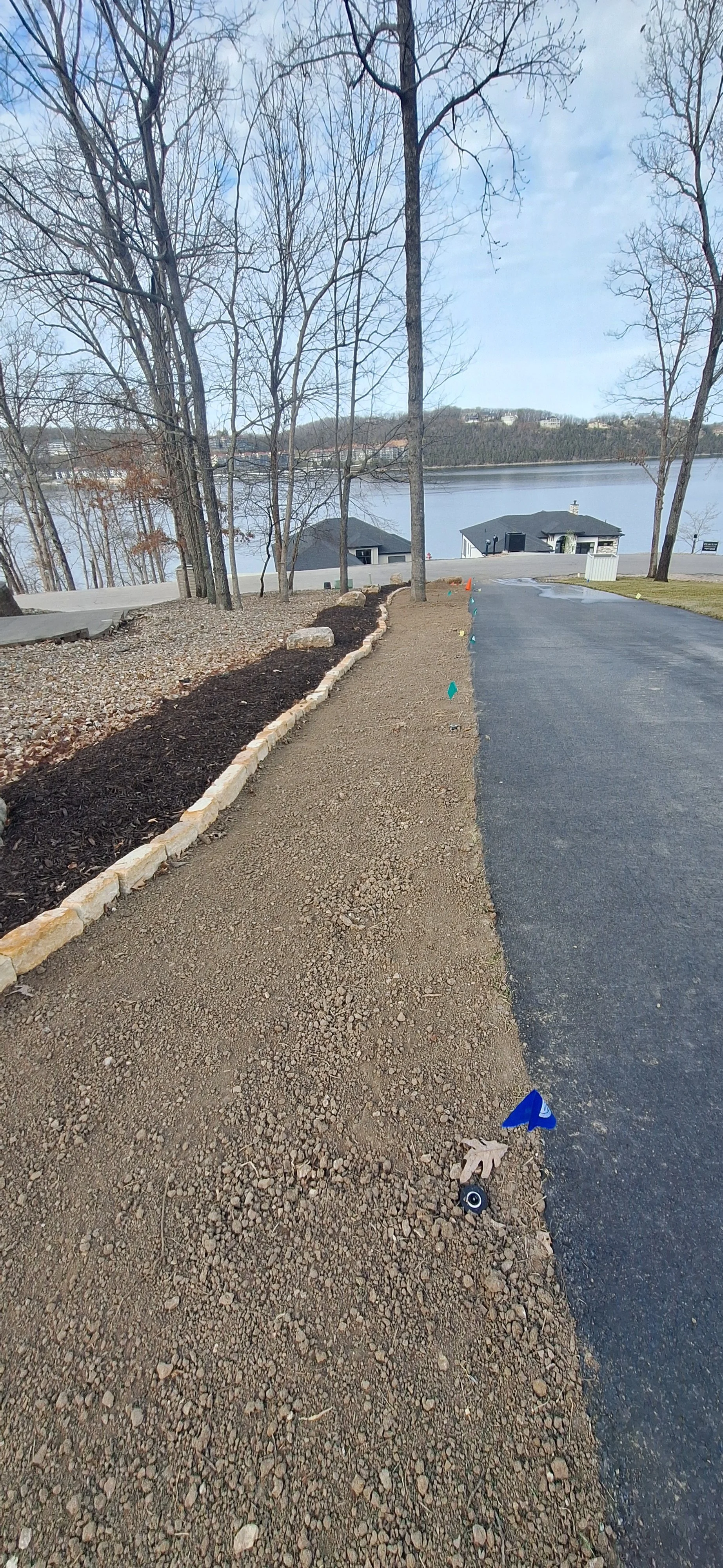 Stone edging, planting berm, mulch, Irrigation, corrected grade, prepping for sod.