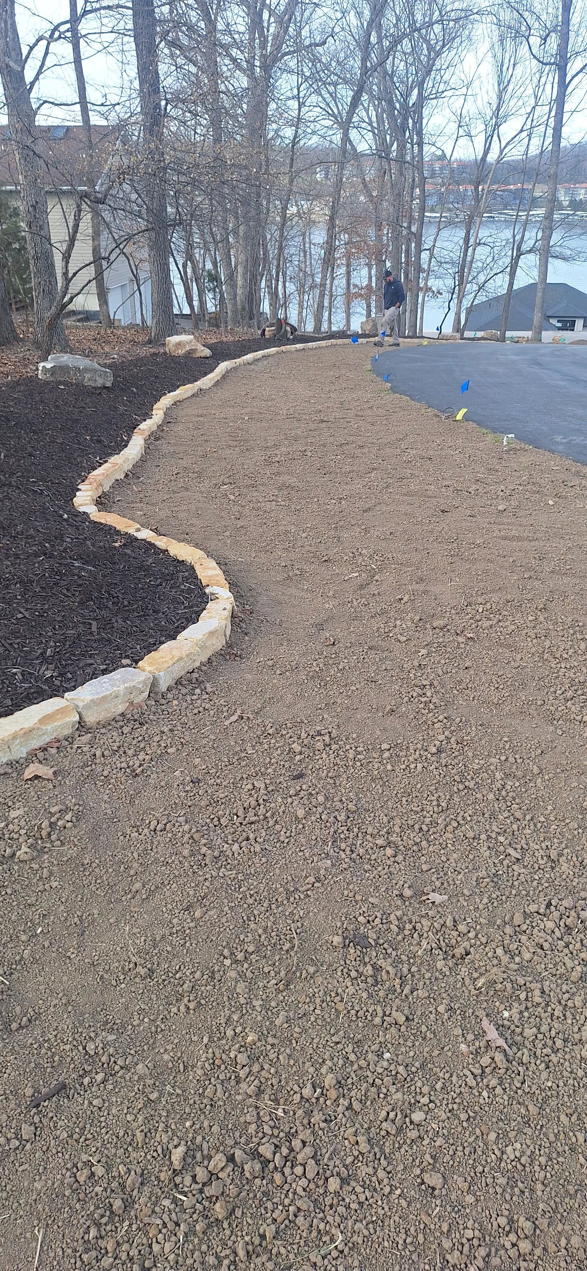 Stone edging, planting berm, mulch, Irrigation, corrected grade, prepping for sod.