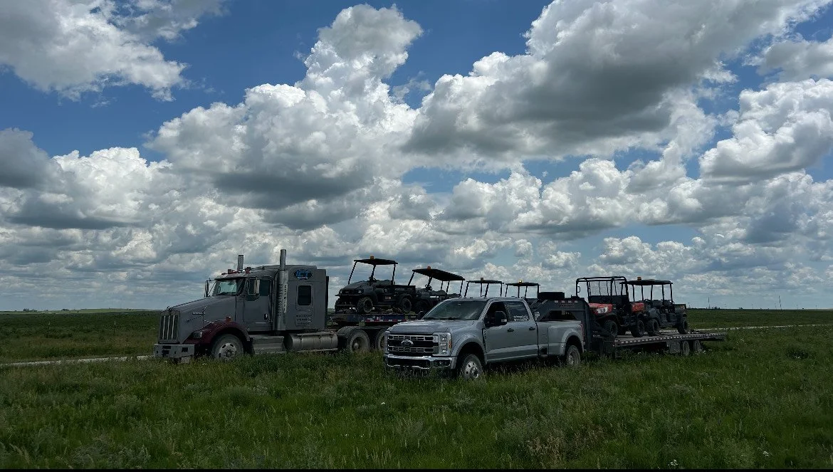 ICT semi and pickup with trailers loaded with utility vehicles