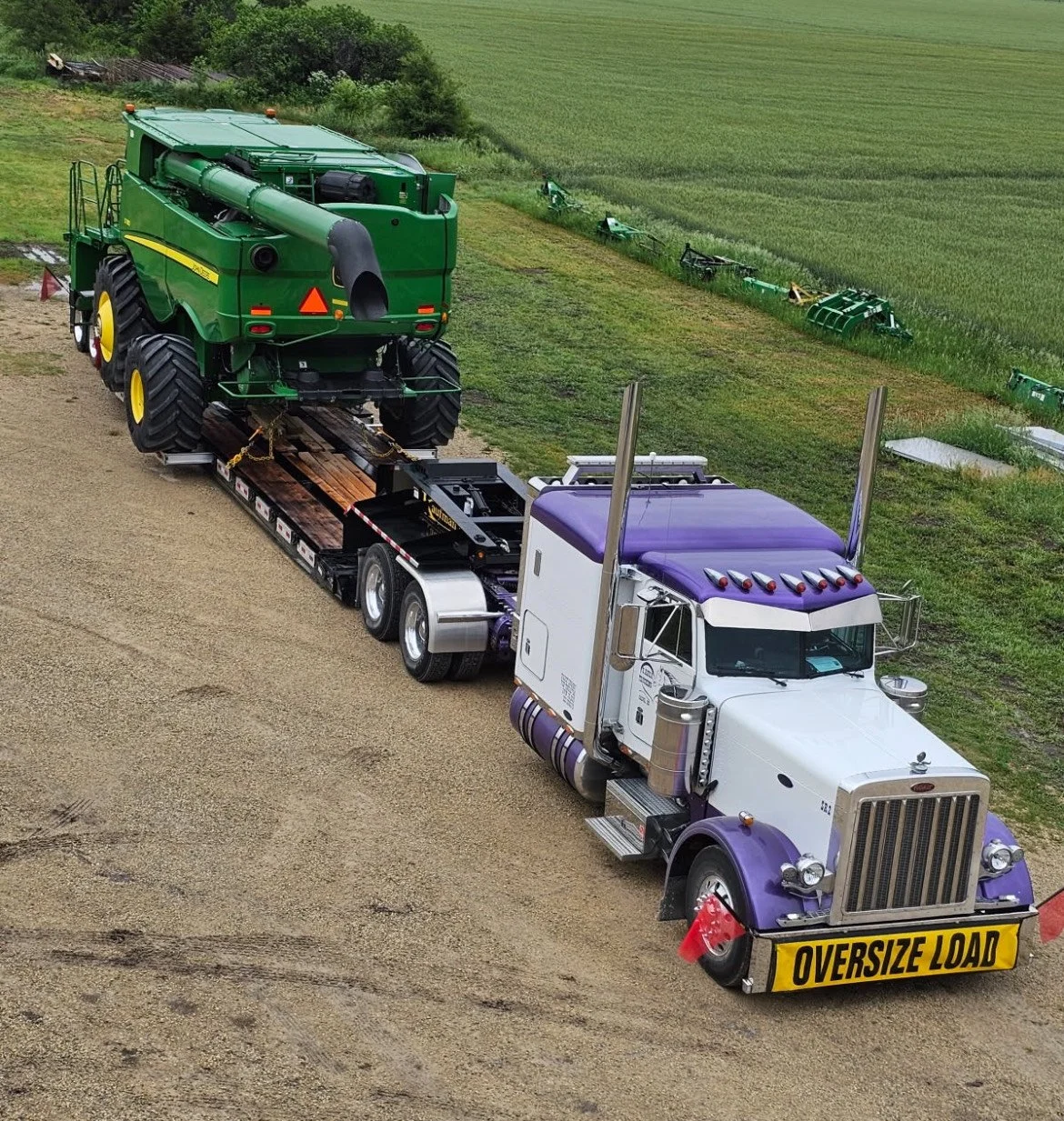 ICT truck hauling an oversize load of farm equipment
