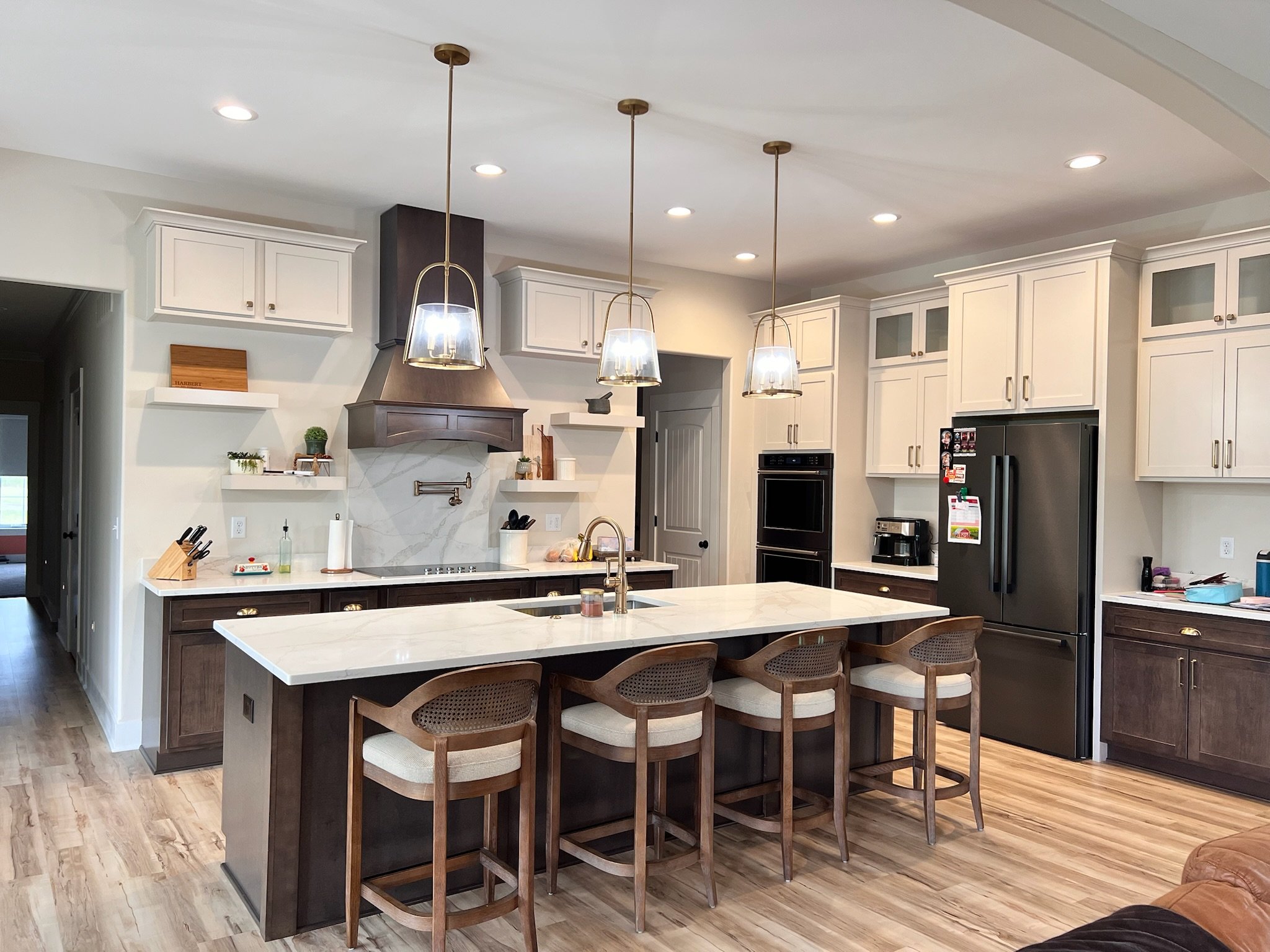 Modern kitchen with island, pendant lights, and dark wood cabinets