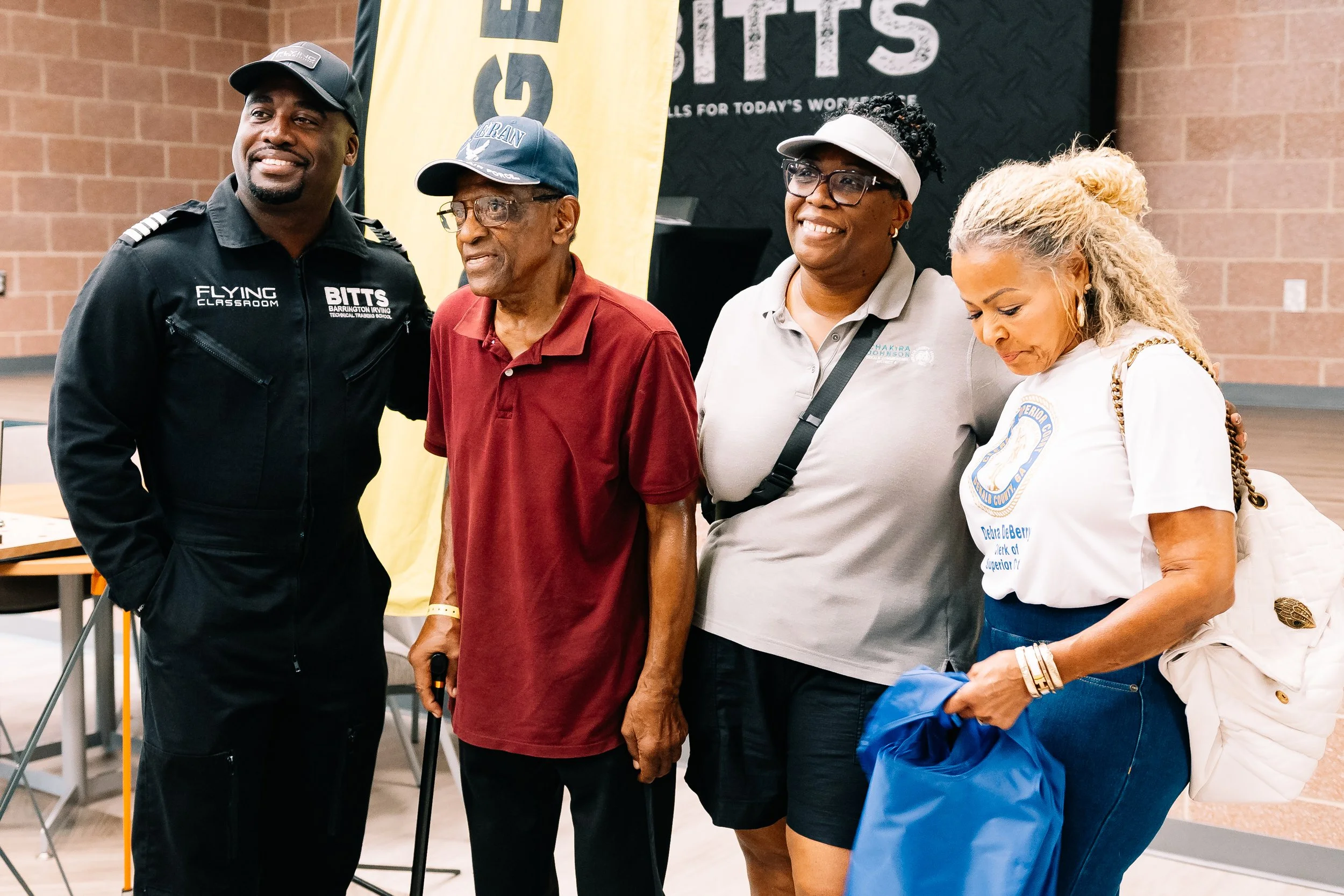 Captain Barrington Irving, an event attendee, Presiding Officer Commissioner Chakira Johnson, and DeKalb County Clerk of Superior Court Debra DeBerry pose together during Chakira’s Cookout.