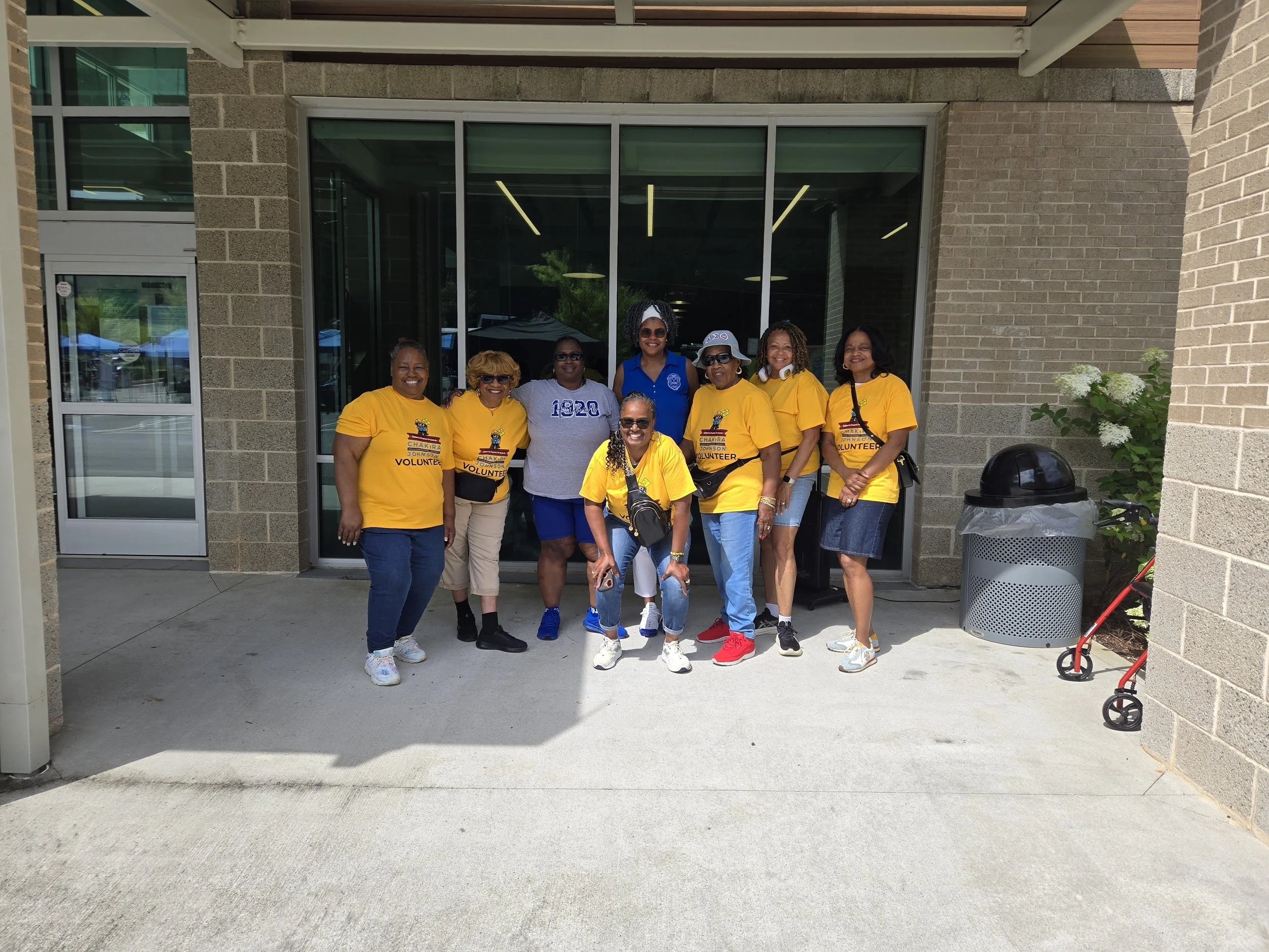 Several of Chakira’s Cookout volunteers, wearing branded yellow event Volunteer t-shirts.