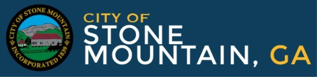 City of Stone Mountain logo with the city seal and the words “City of Stone Mountain, GA” in gold and white on black.