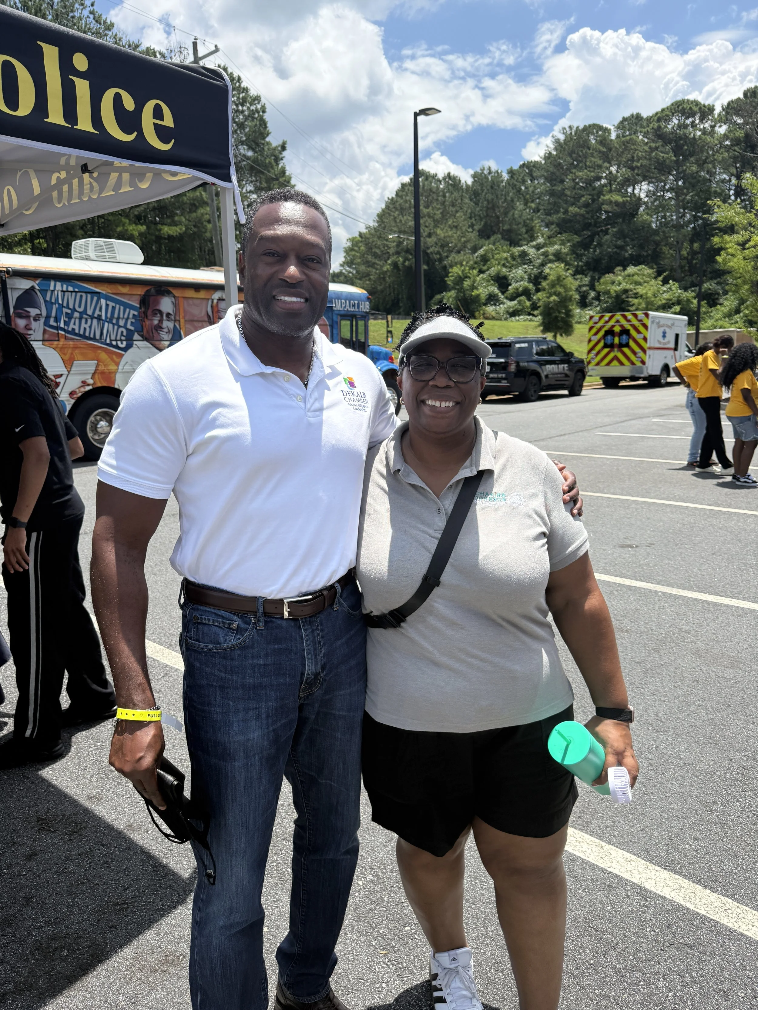 DeKalb Chamber of Commerce President and CEO Frankie Atwater and Commissioner Chakira Johnson smile for a photo outdoors at Chakira’s Cookout.
