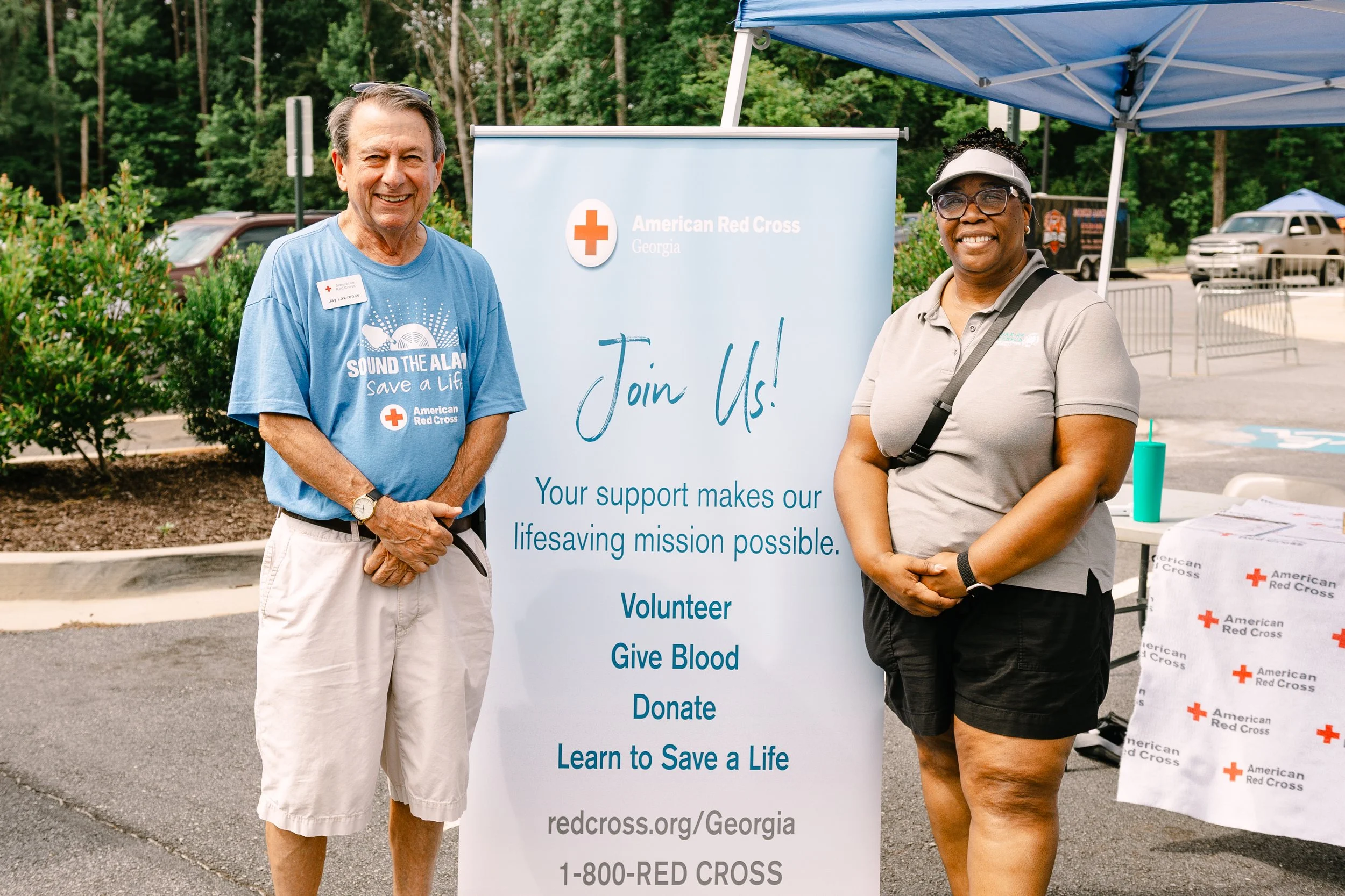 Commissioner Chakira Johnson poses with an American Red Cross representative beside the organization’s information display at Chakira’s Cookout.