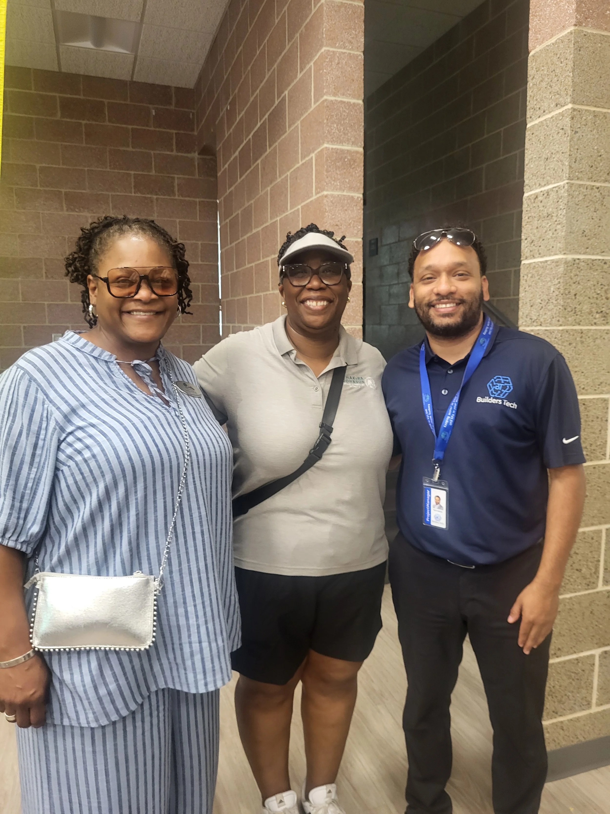 From left, a DeKalb County Parks, Recreation & Cultural Affairs representative, Commissioner Chakira Johnson and Builders Tech CEO and District 4 board appointee Taha Addow pose together.