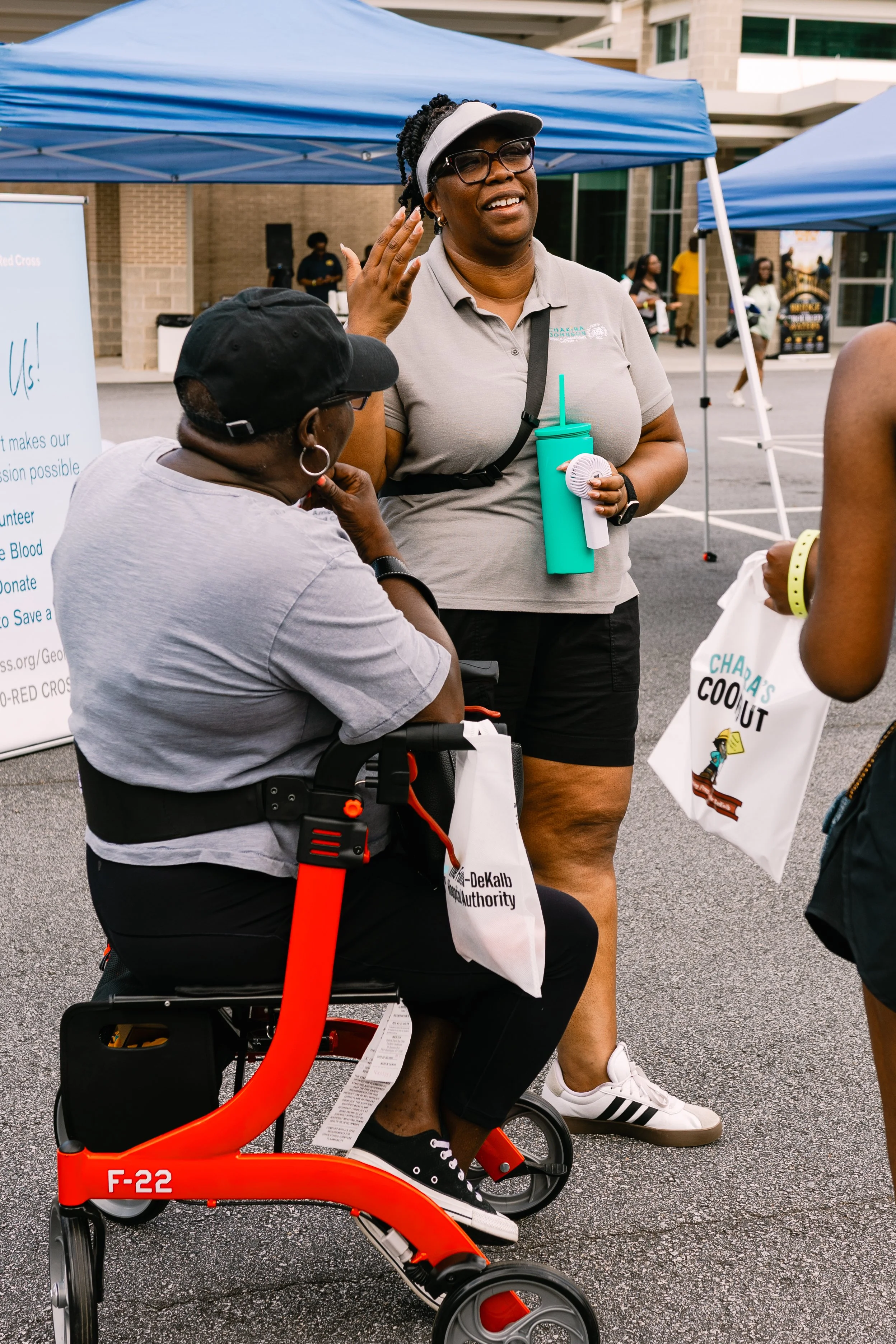 Commissioner Chakira Johnson smiles and chats with a couple of attendees during Chakira’s Cookout.