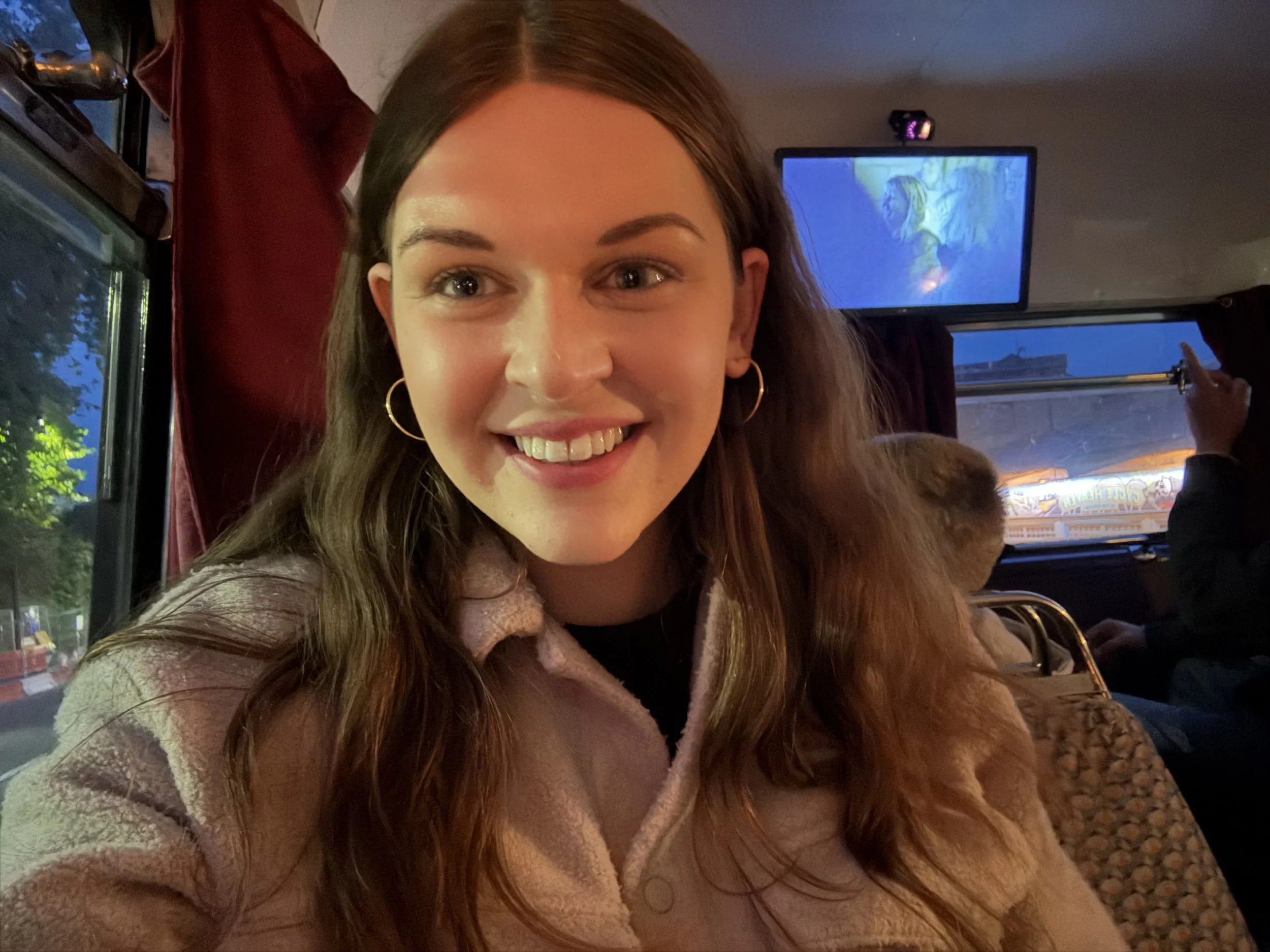 Person with long hair, smiling at the camera.