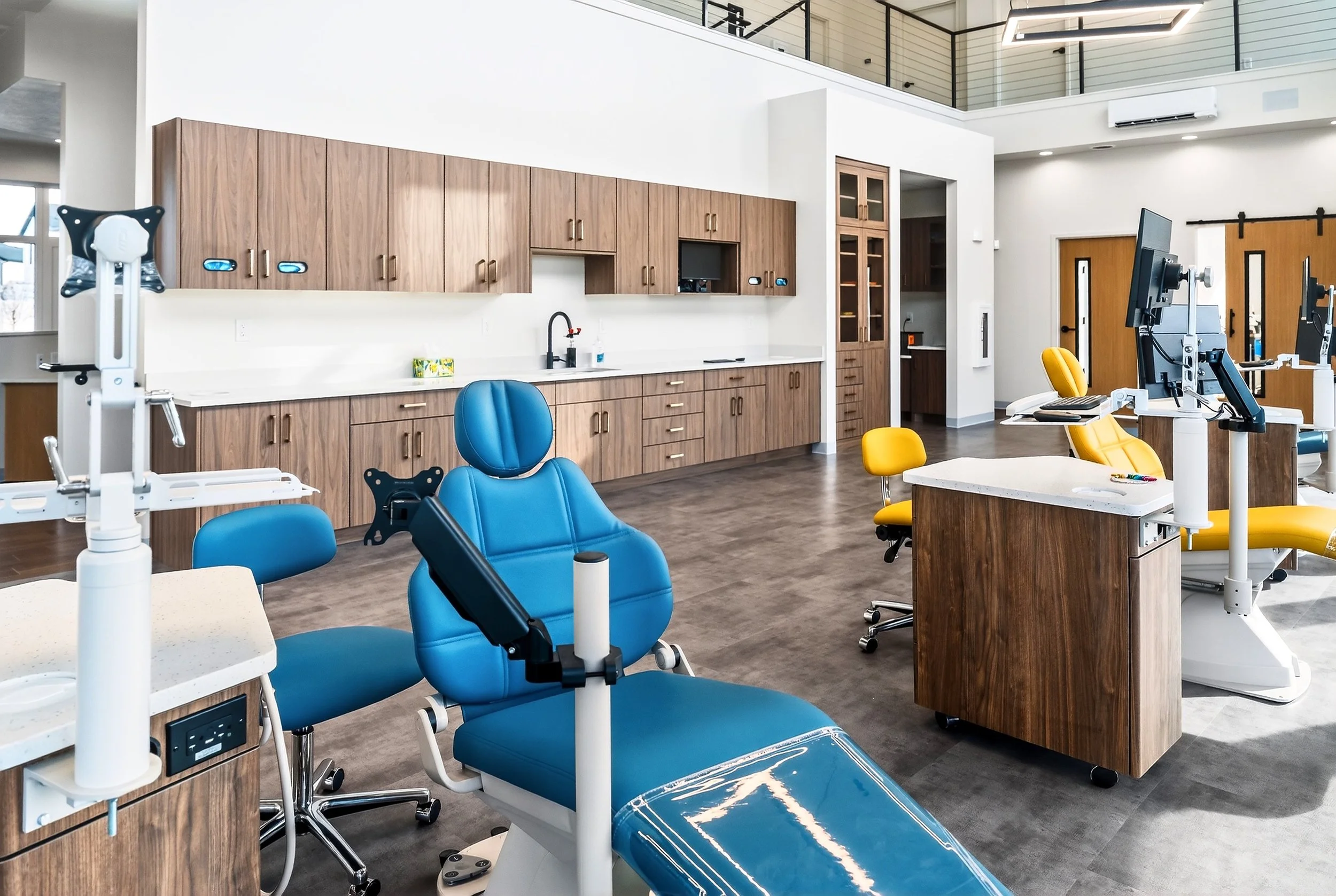 A warm orthodontic clinic with modern dental chairs and equipment.