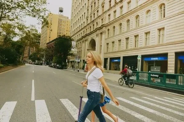 Image of Dr. Becky crossing the street with effortless hair and makeup by Maysoon Faraj, photographed for the New York Times magazine.