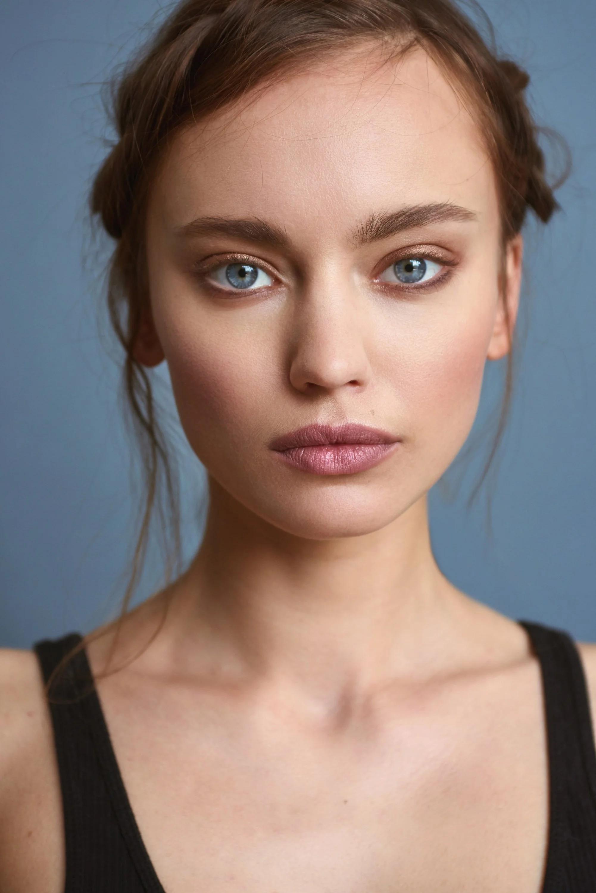 Close-up beauty portrait featuring glowing skin and effortless hair by New York makeup artist and hairstylist