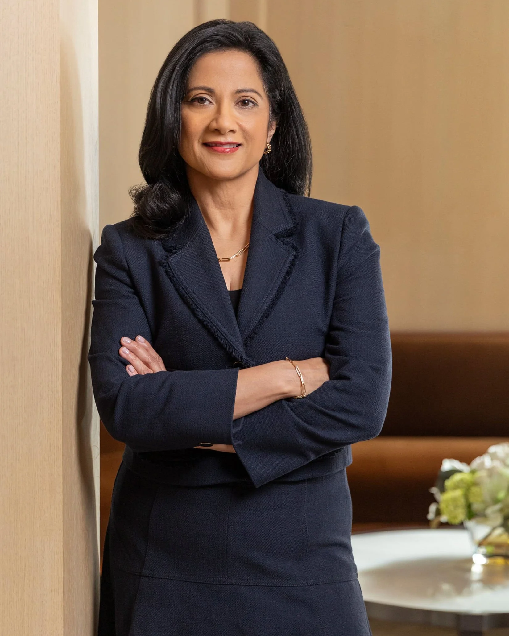 Professional headshot of a woman with sleek hair and subtle natural makeup by New York hair and makeup artist