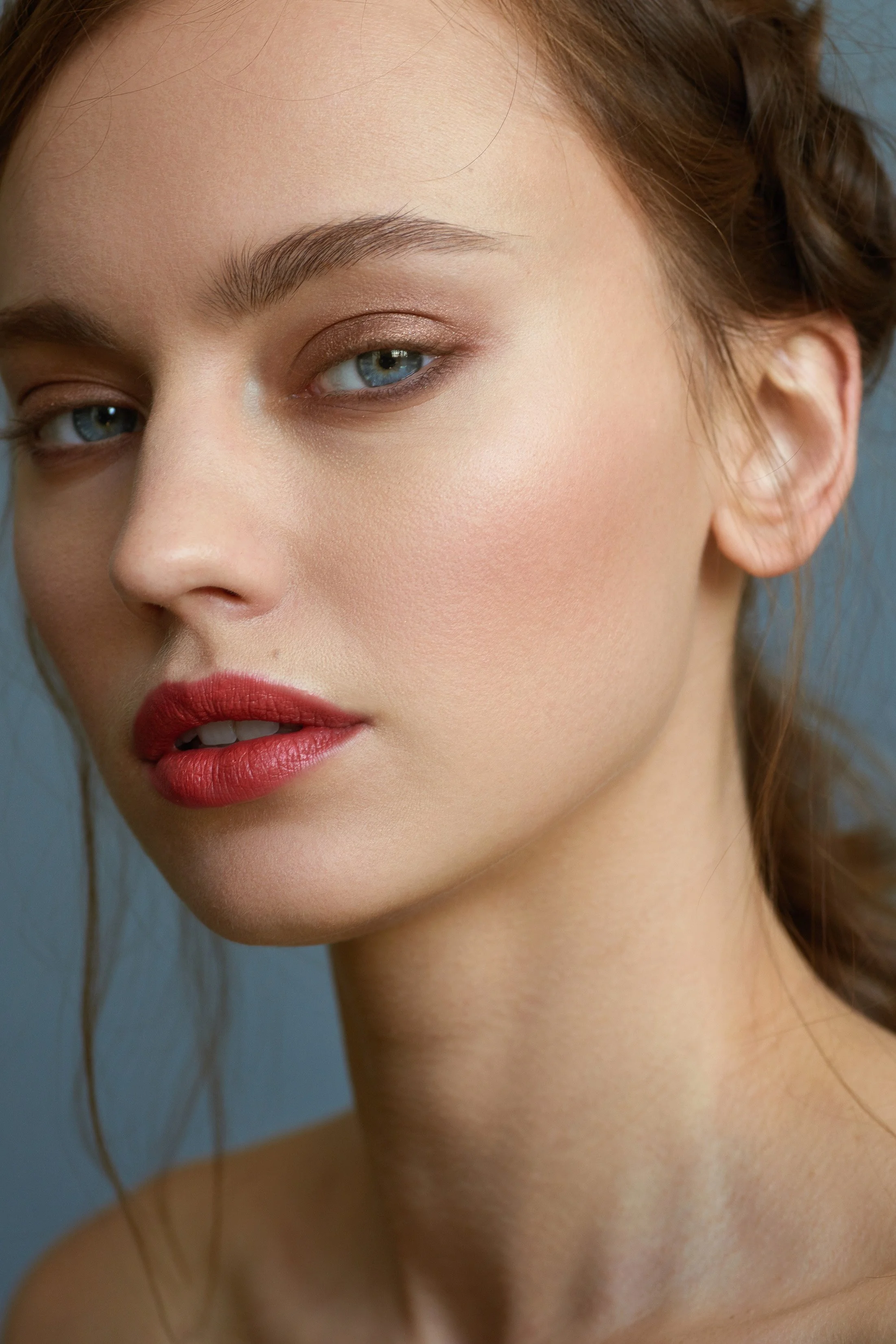 Close-up beauty portrait featuring glowing skin and effortless hair by New York makeup artist and hairstylist