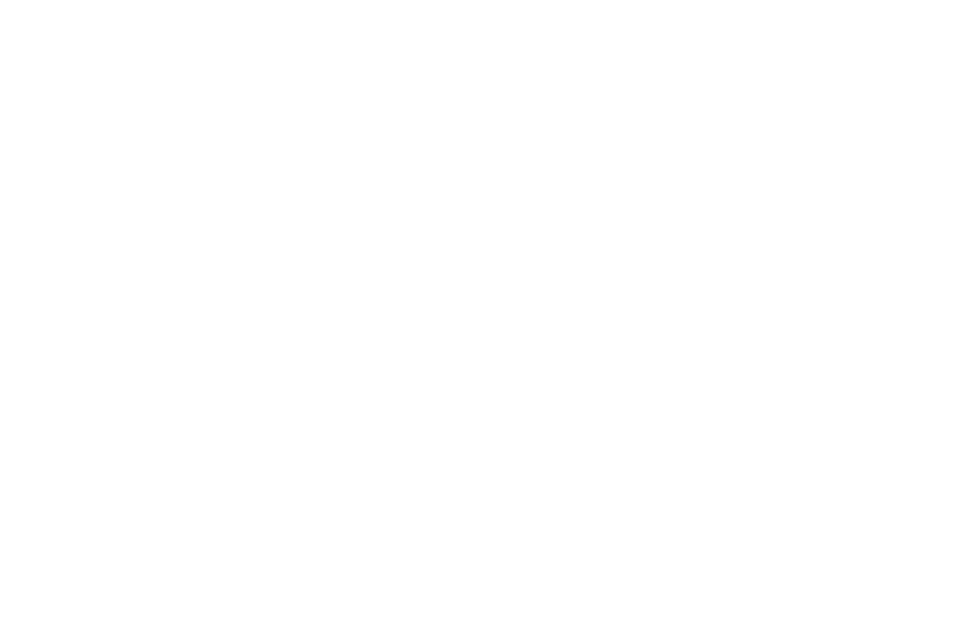 A wedding cake with multiple layers decorated with white frosting and flowers.