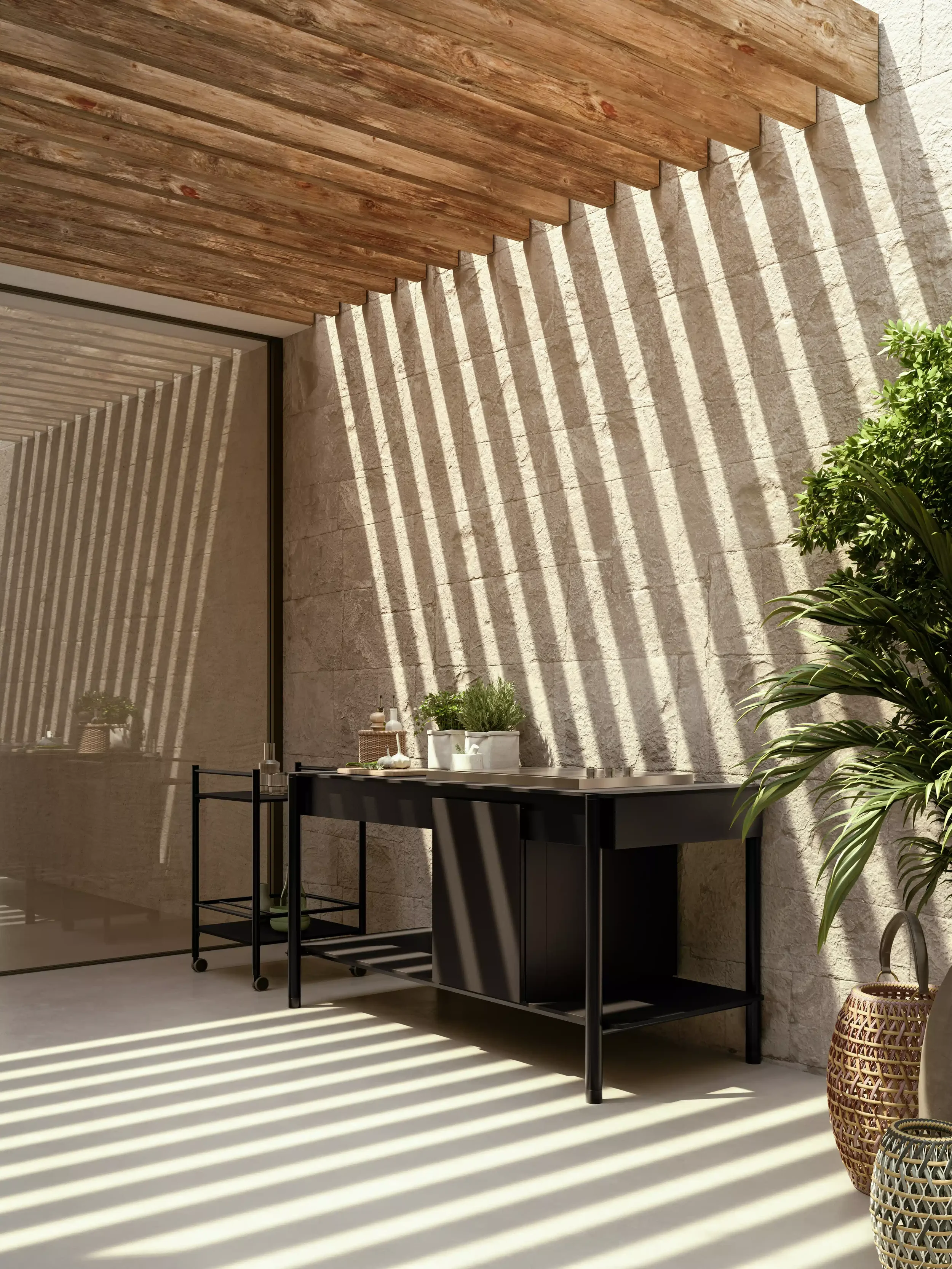 photo d'une cuisine exterieure sur une terrasse avec l'ombre d'une pergola et des arbres