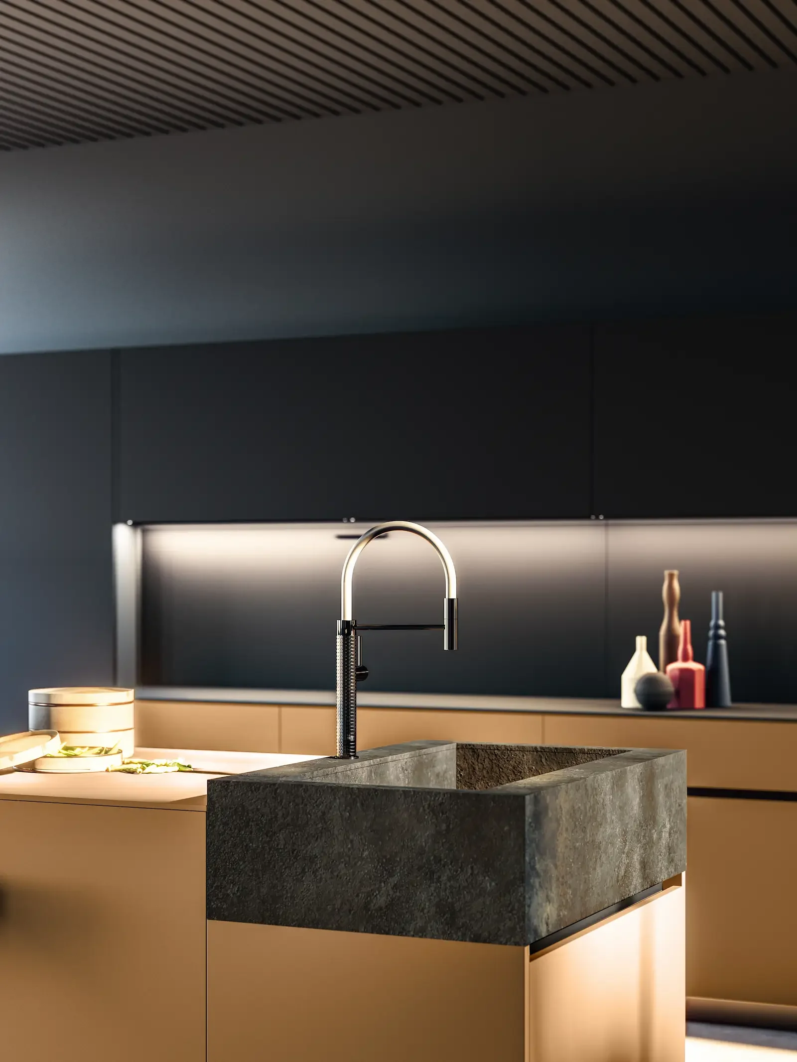 Cuisine contemporaine haut de gamme exposée dans le showroom Oleksiak à Clermont-Ferrand, avec îlot central et évier en pierre.