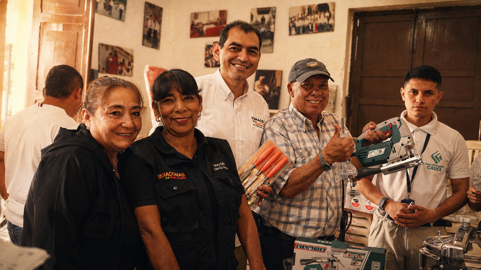 Grupo de personas en una sala, algunas sosteniendo herramientas eléctricas, sonriendo y posando para la cámara.