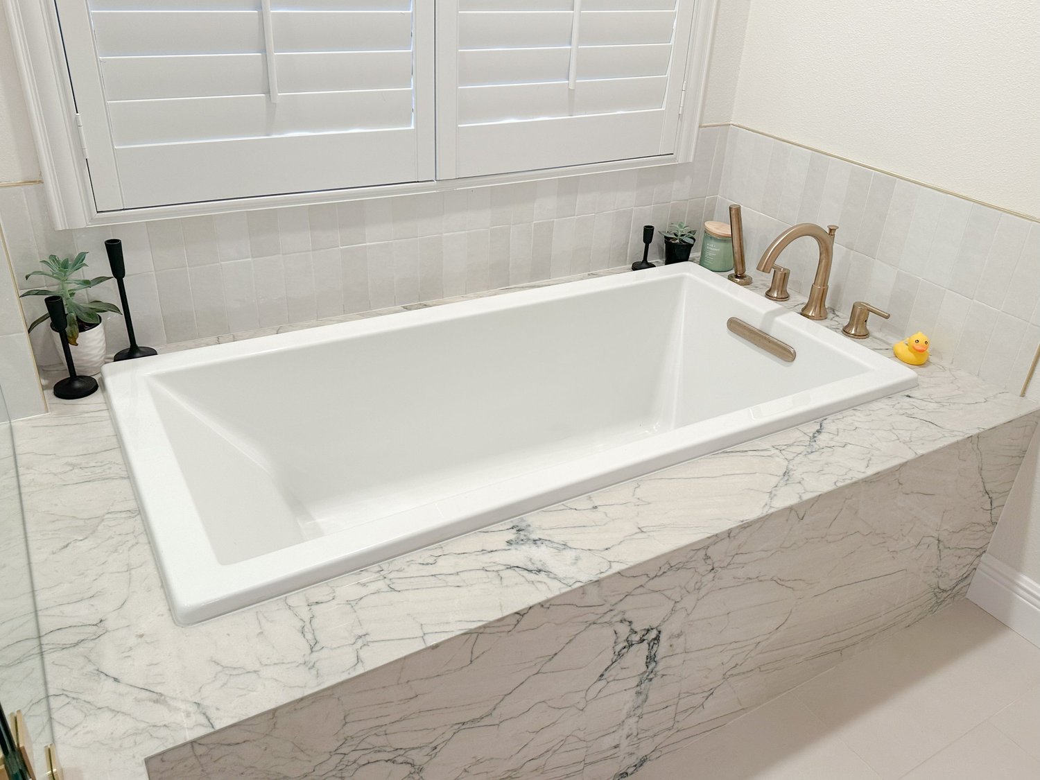 Primary bathroom remodel with built-in soaking tub, waterfall quartzite surround and gold fixtures