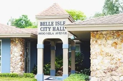 Belle Isle City Hall building with stone columns and tile roof on Nela Avenue in Belle Isle, Florida.