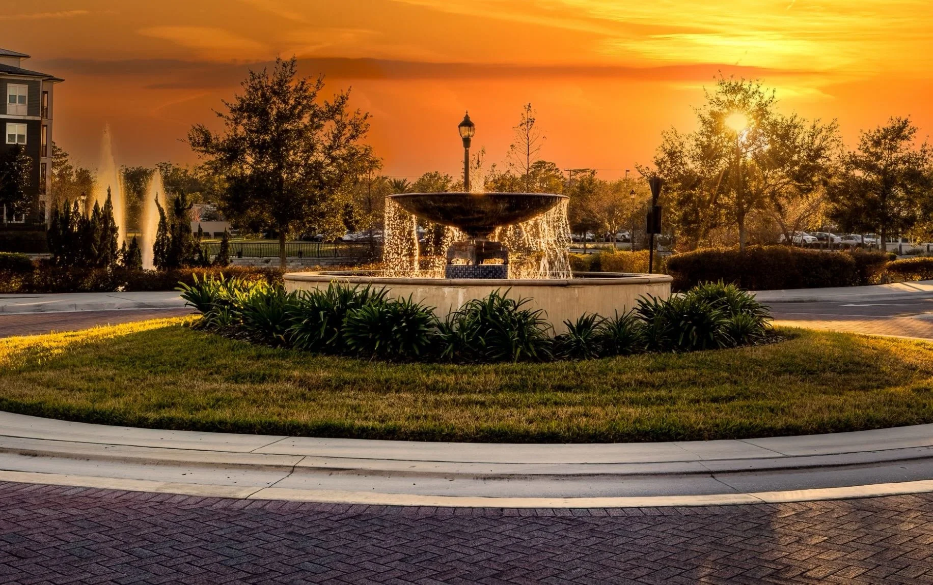 Illuminated fountain in a landscaped roundabout at sunset in Casselberry, Florida.