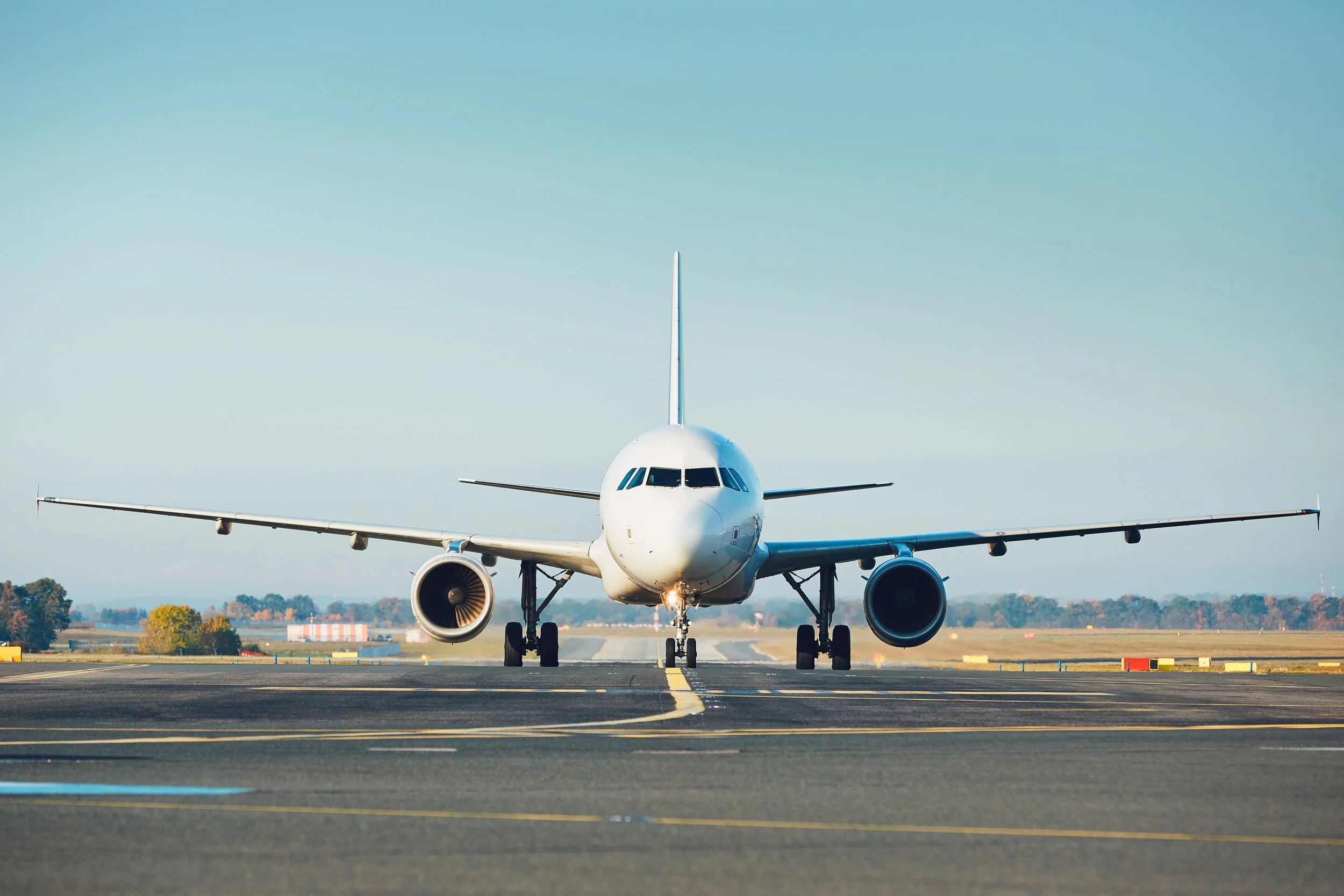 Front view of a commercial airplane on a runway.