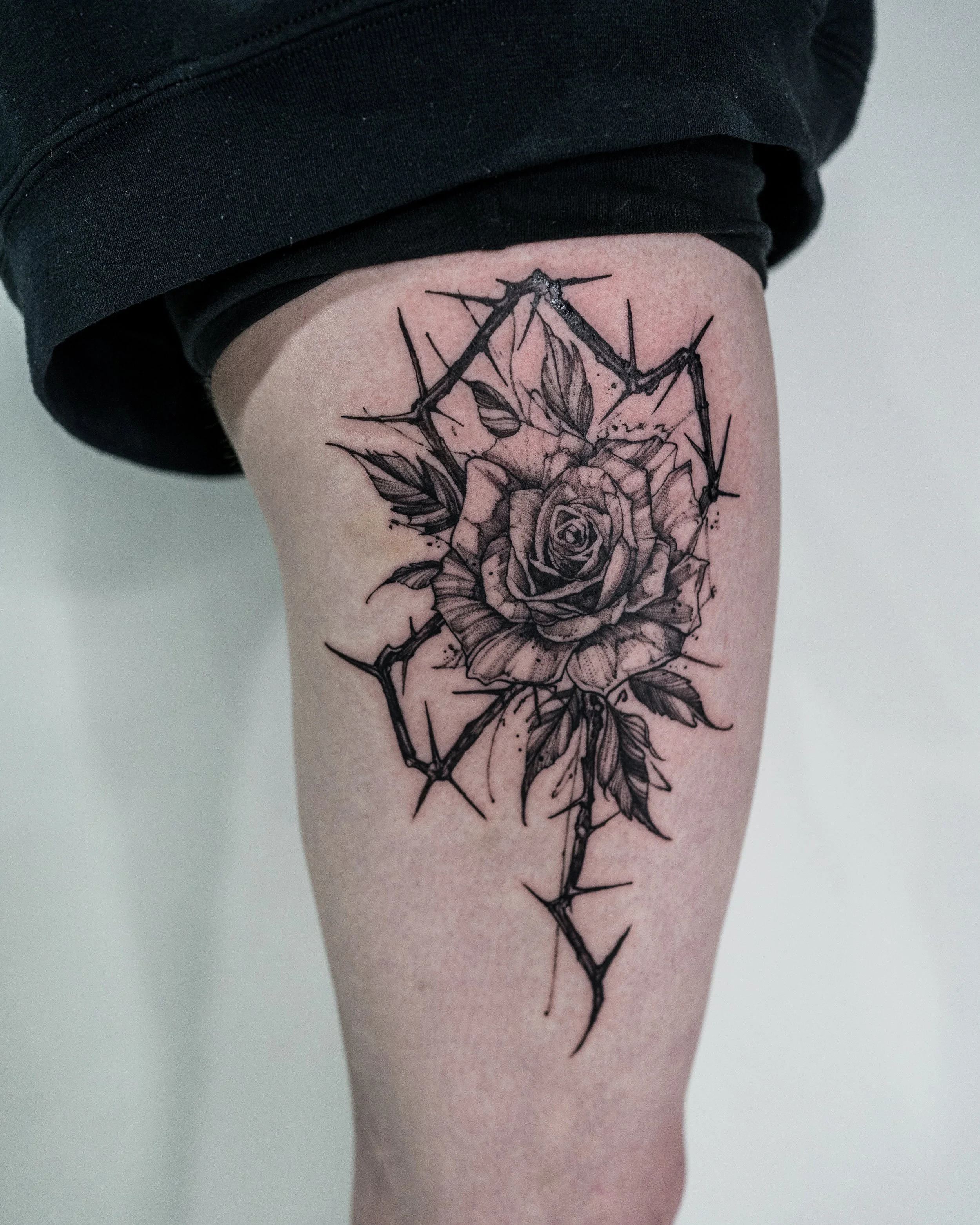 rose tattoo on thigh by jay c tattoo in brighton - uk