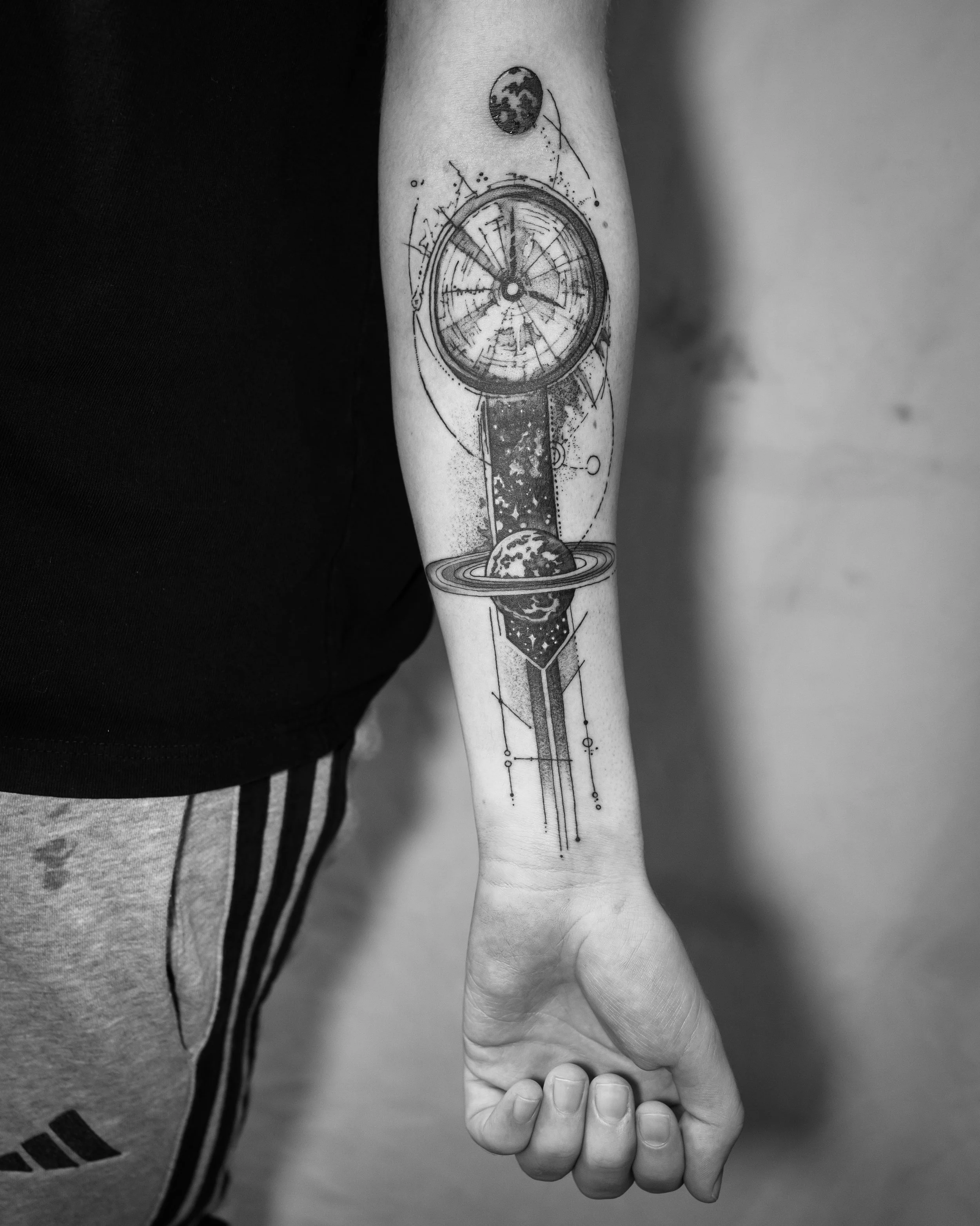 Brighton tattoo featuring a clock, planets, and abstract scientific elements.