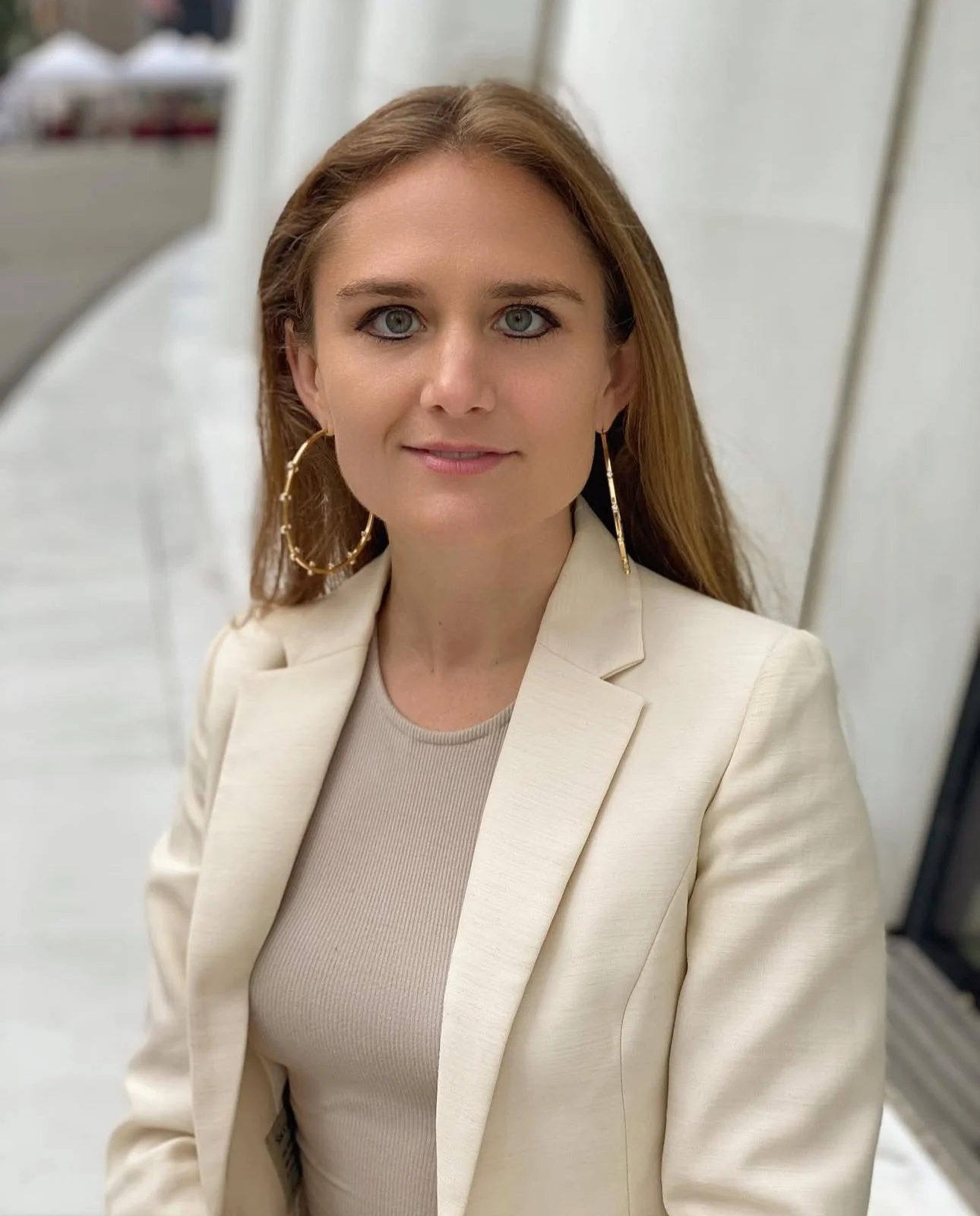 Portrait of investigative journalist Emily Palmer photographed outside the 9/11 Oculus in New York City, used on her About page to represent her crime reporting and narrative nonfiction work.